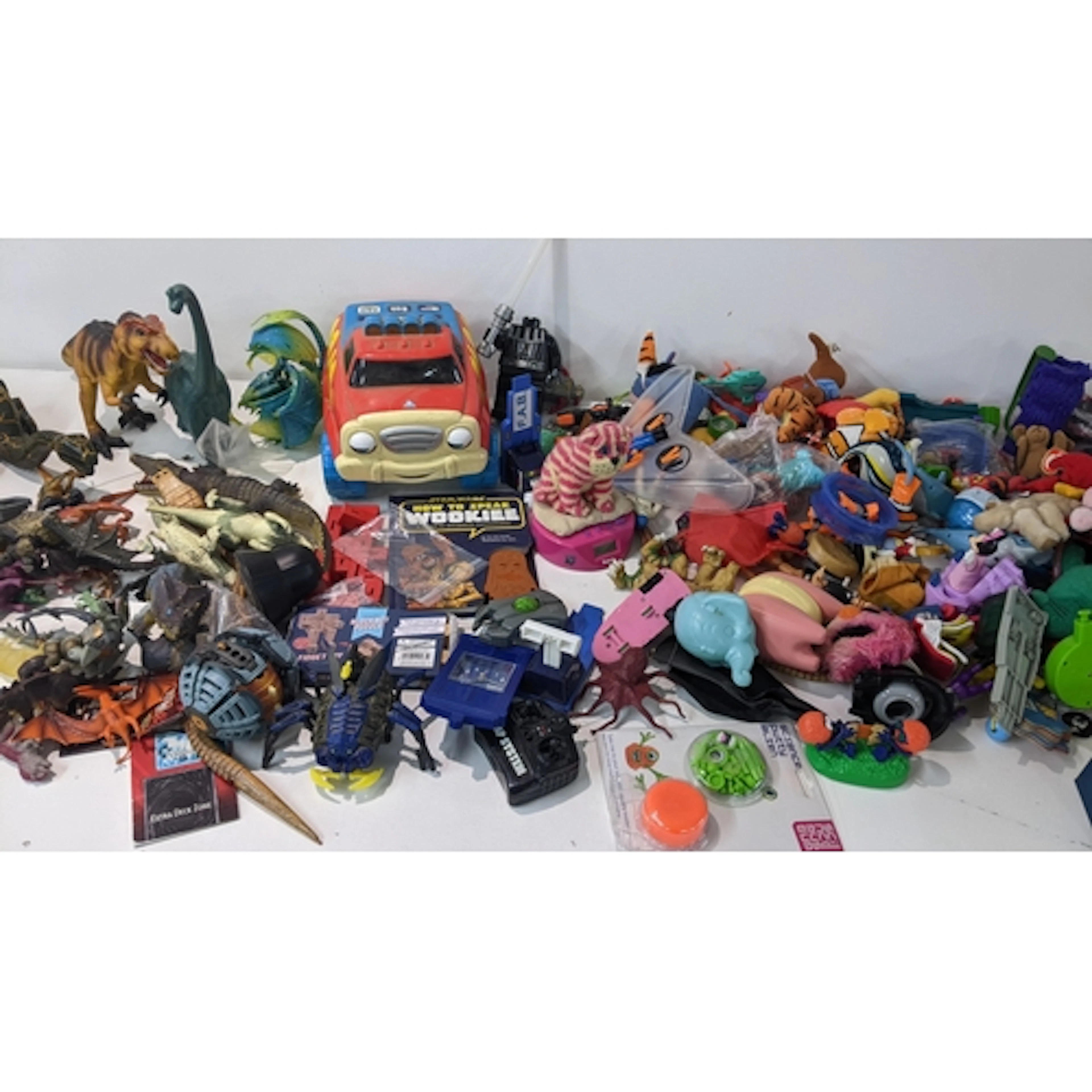 A mixed lot of toys to include Happy Meal toys, Action Man, ...