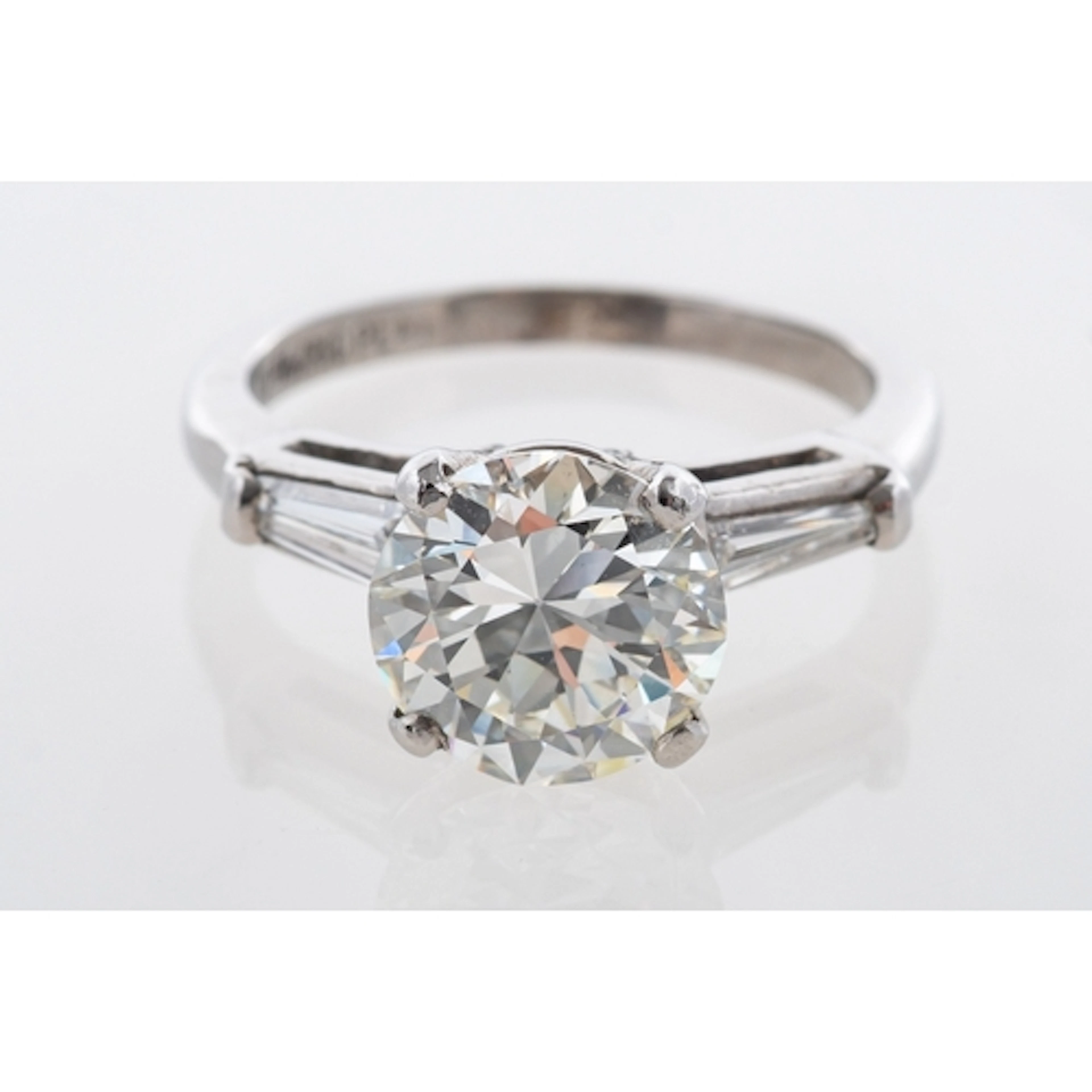 A diamond solitaire ring, featuring a modern round brilliant...