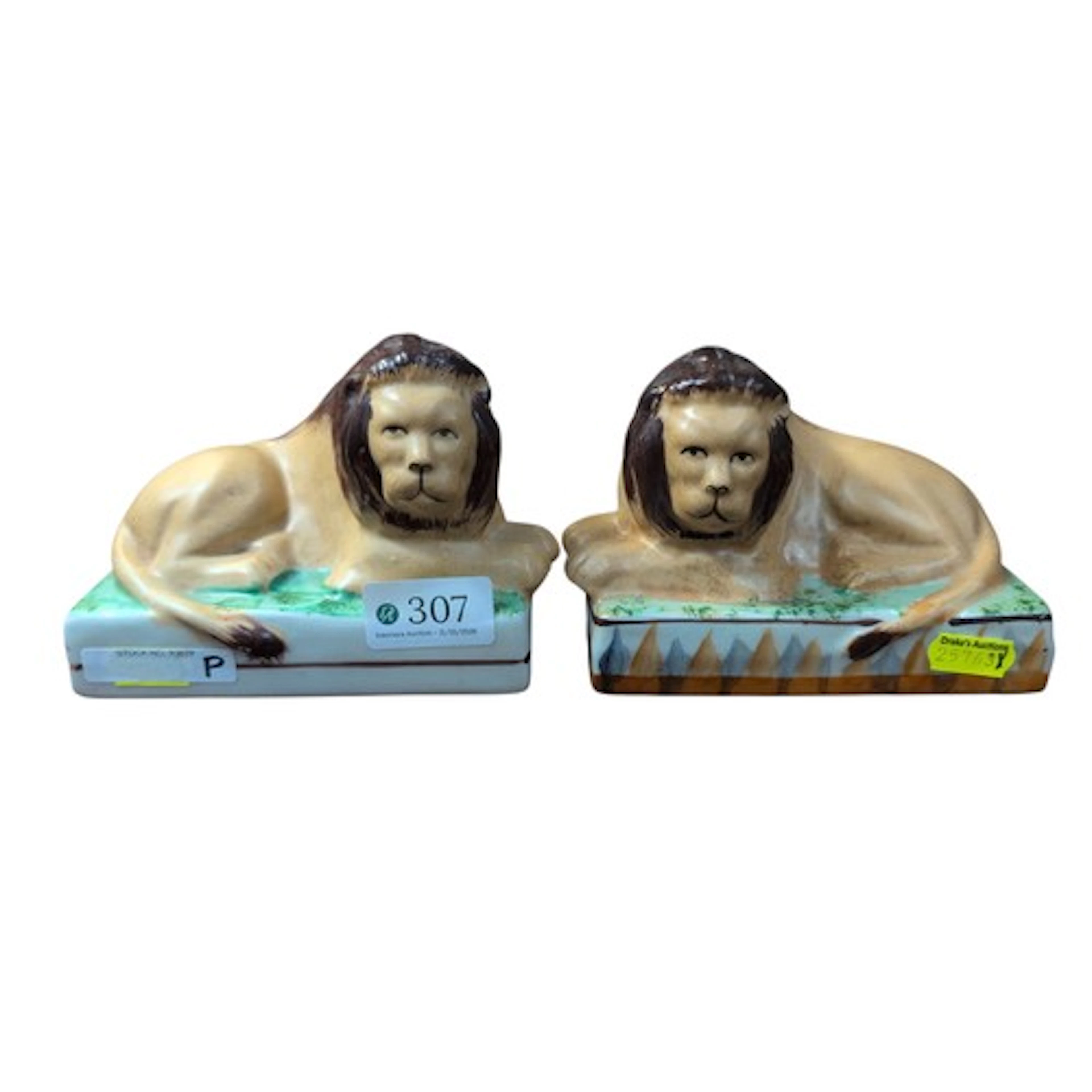 Two Staffordshire-style recumbent lions