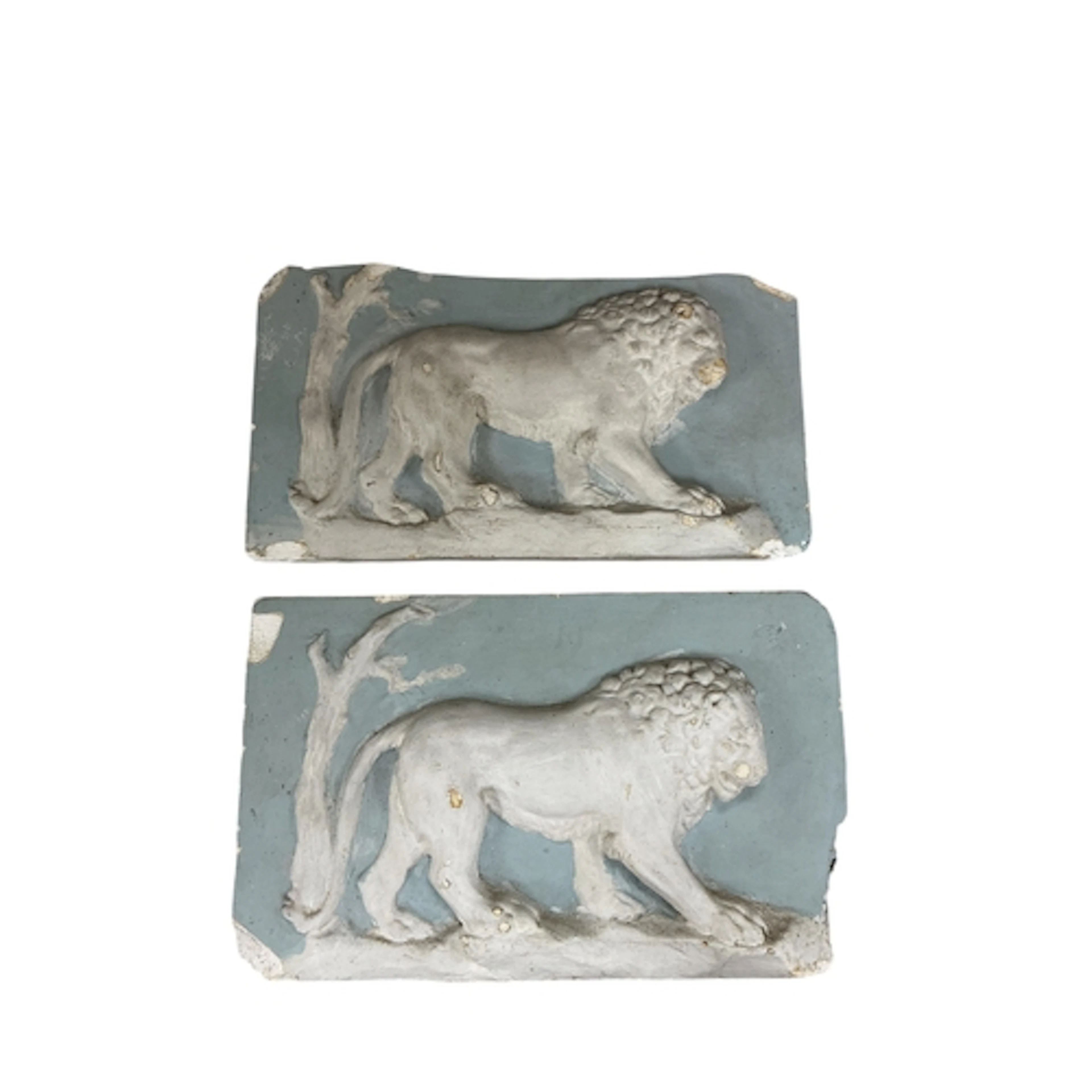 A pair of painted cast plaster lion passant rectangular plaq...