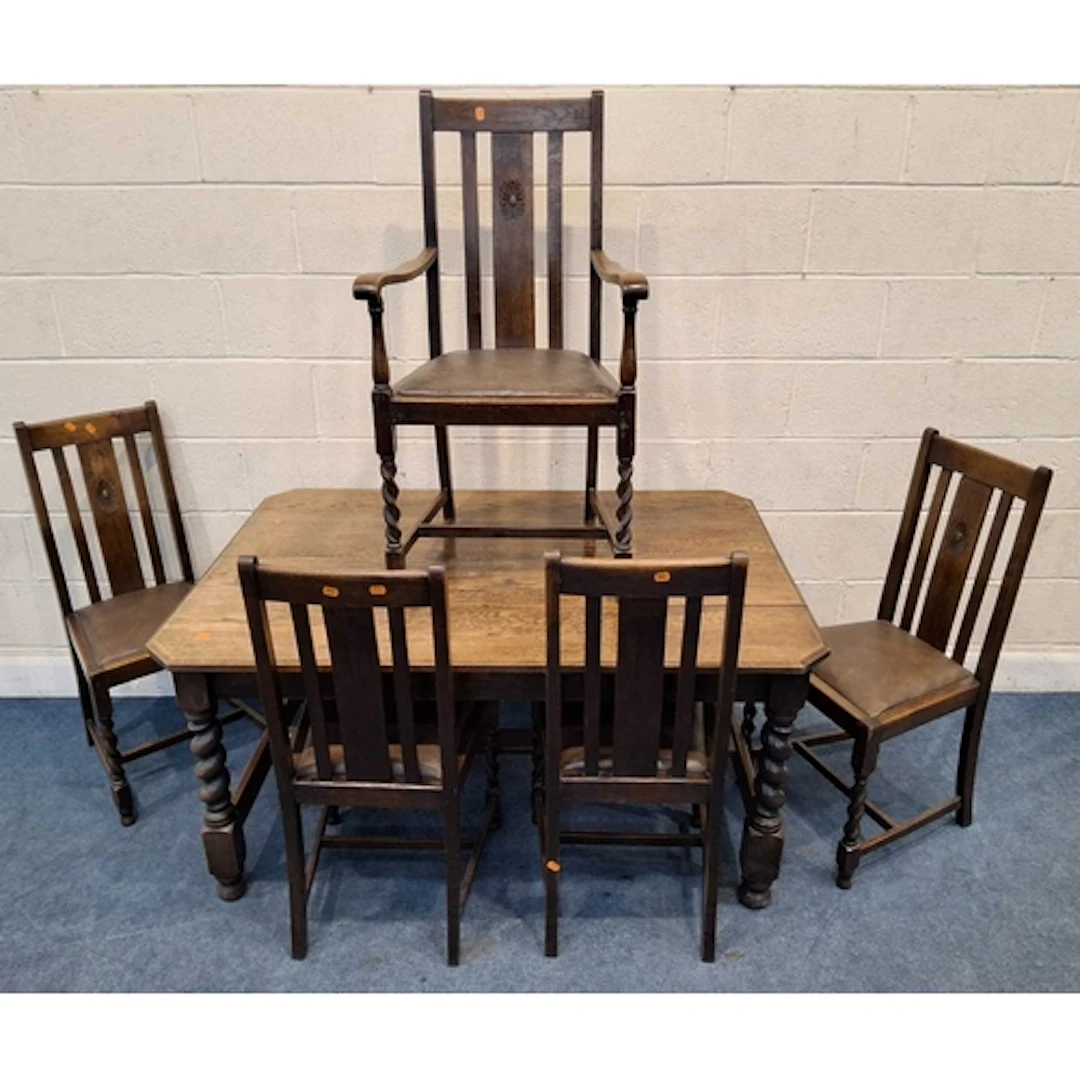 AN EARLY 20TH CENTURY OAK DINING TABLE, raised on barley twi...
