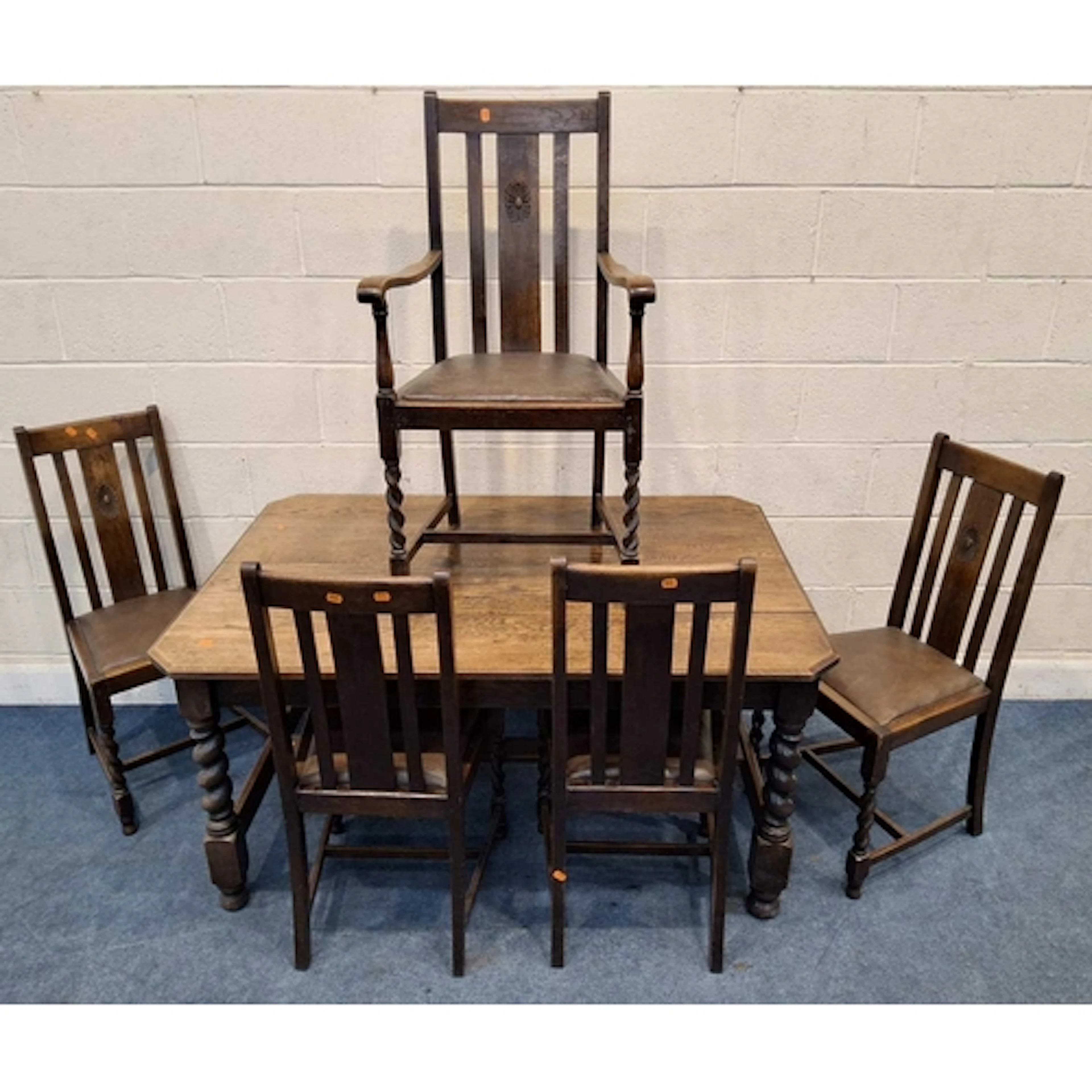 AN EARLY 20TH CENTURY OAK DINING TABLE, raised on barley twi...