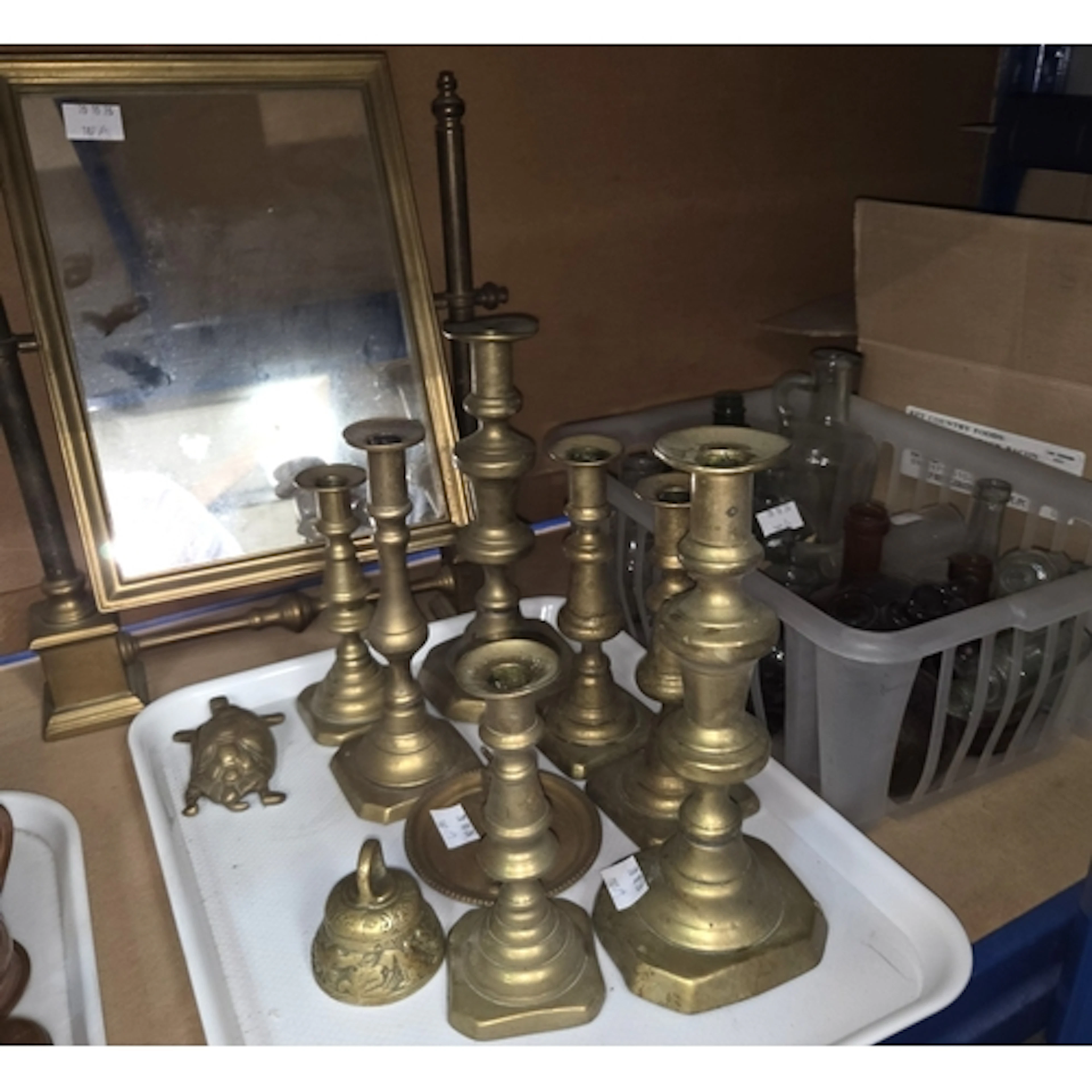 A brass dressing table mirror, brass candlesticks and a sele...