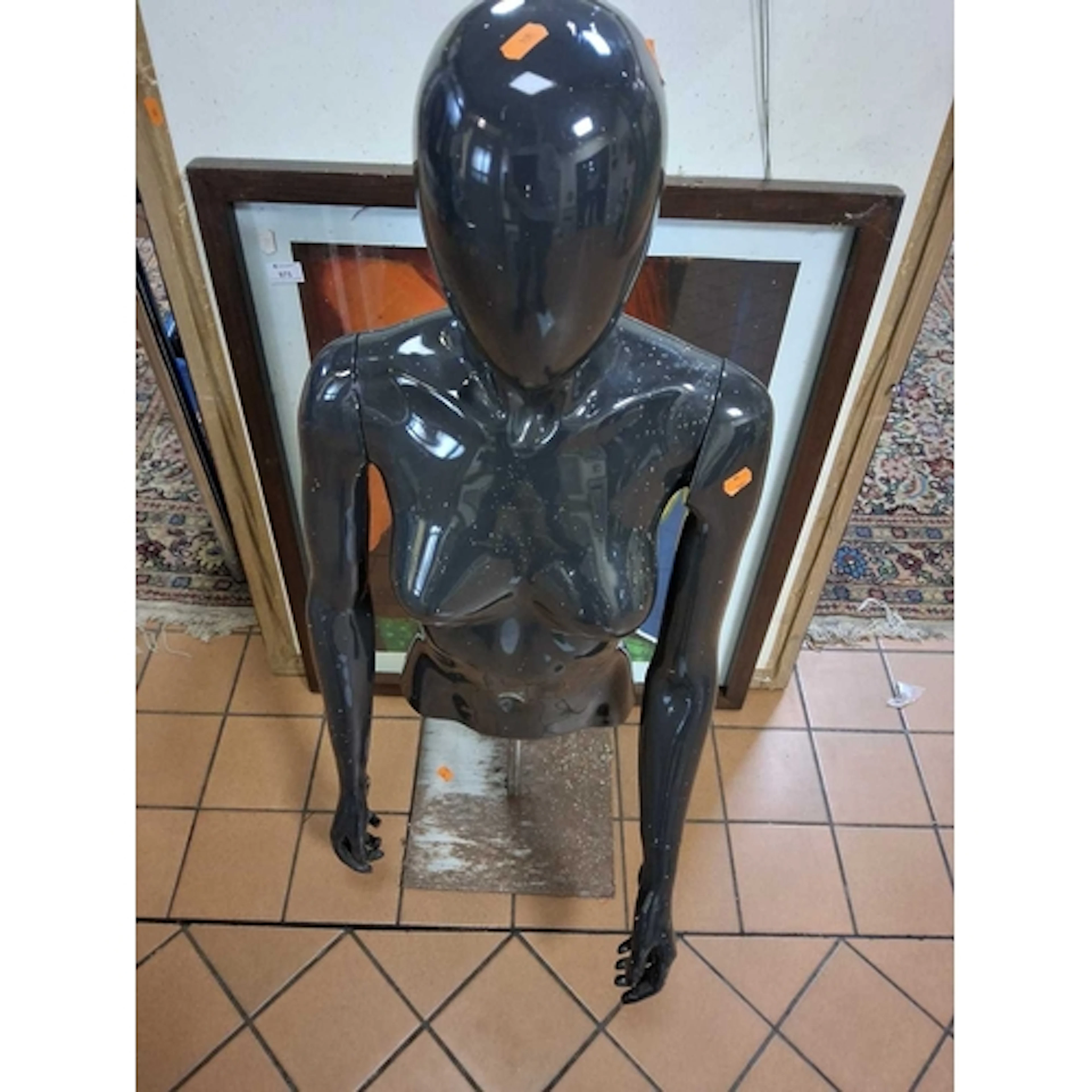 A GROUP OF A BLACK TORSO MANNEQUIN AND THREE AMATEUR ARTISTS...