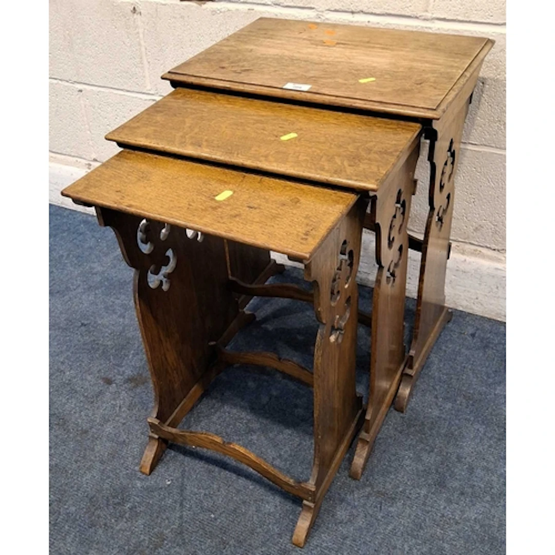 AN EARLY 20TH CENTURY OAK NEST OF THREE TABLES, each leg wit...