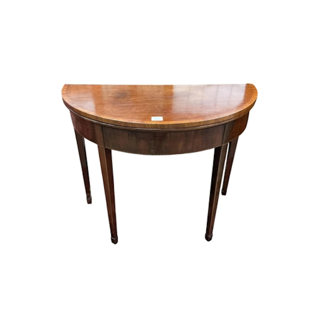 A George III mahogany demi lune fold over tea table, width 9...