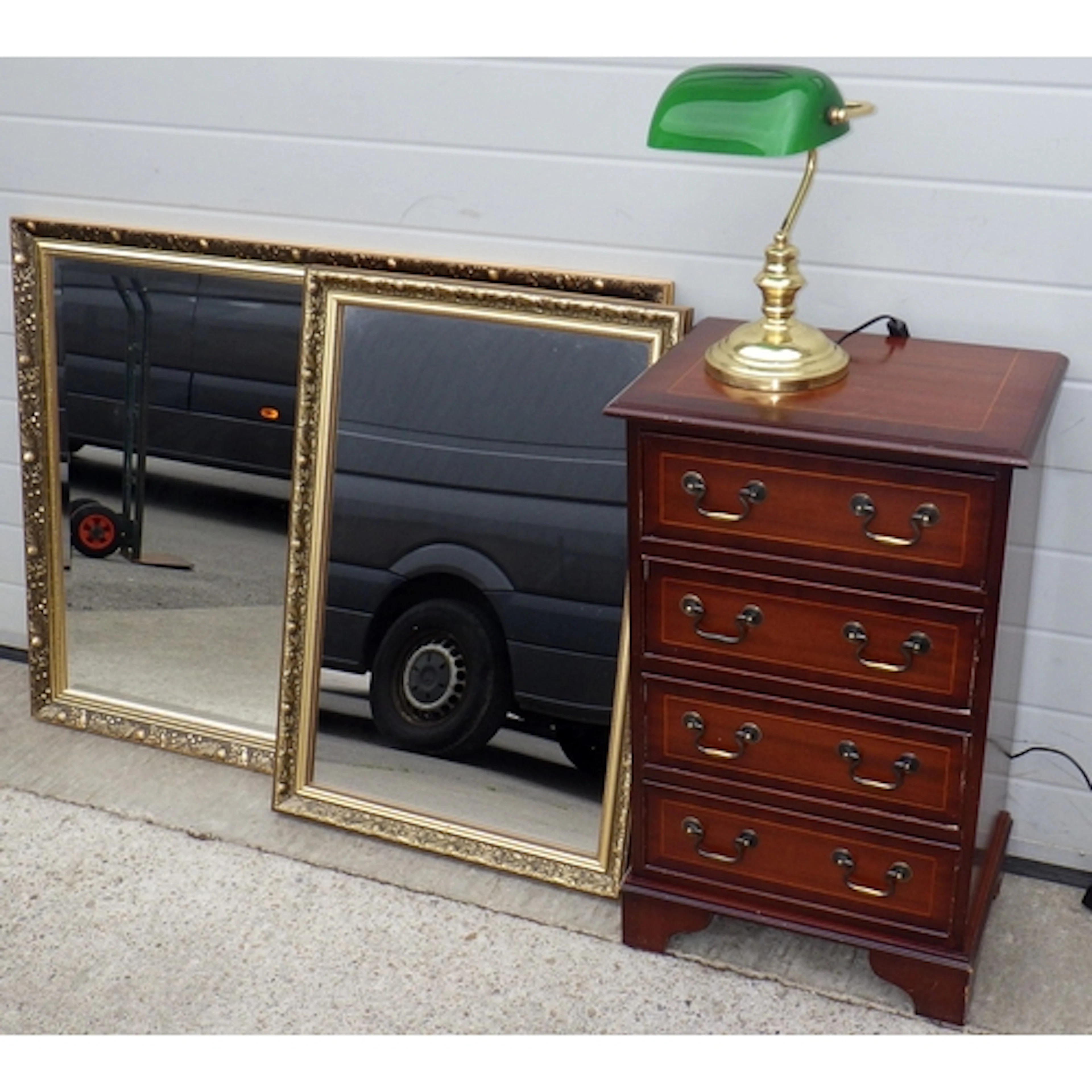 A small reproduction mahogany chest of drawers, desk lamp an...