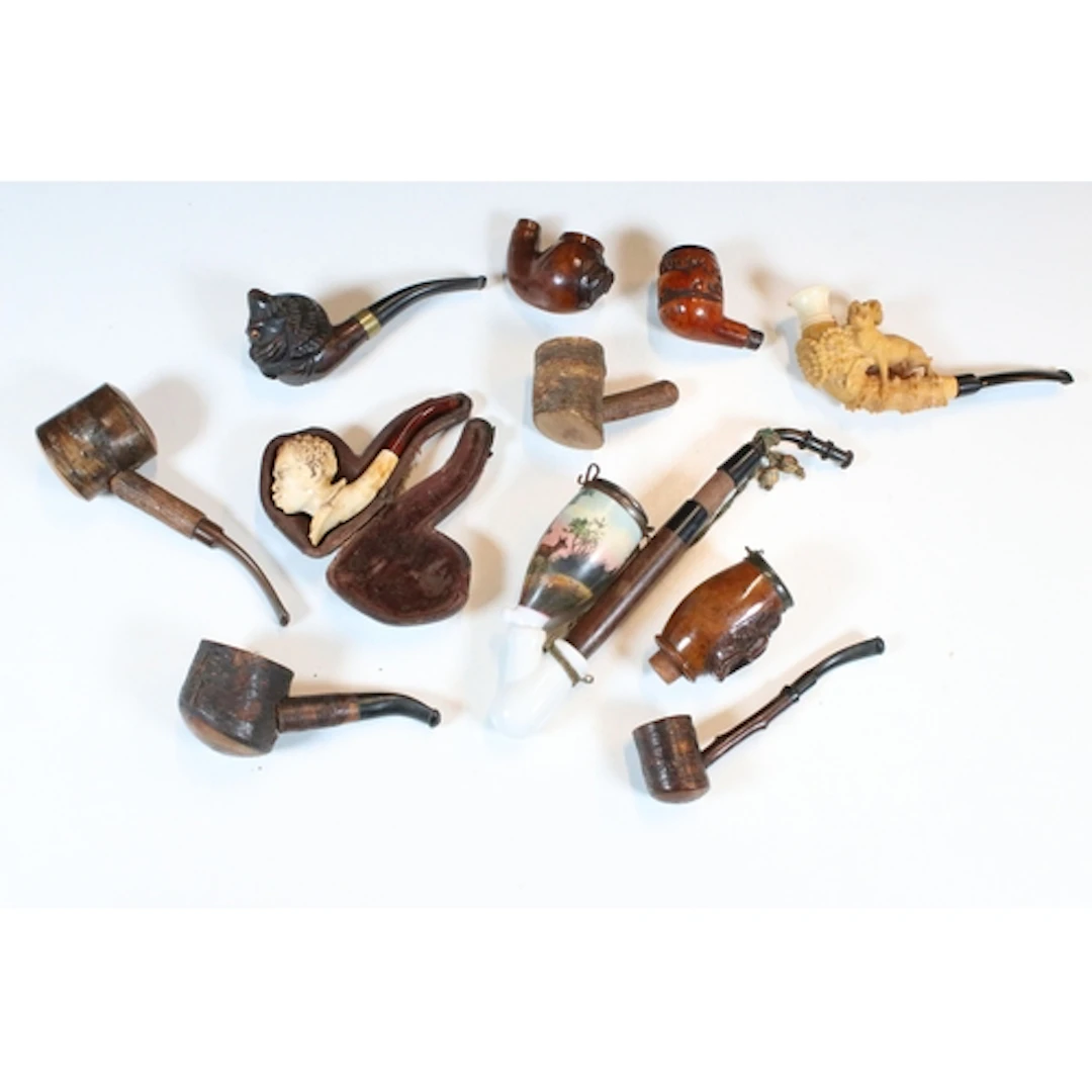 Smoking paraphernalia to include a hand-carved wooden pipe i...