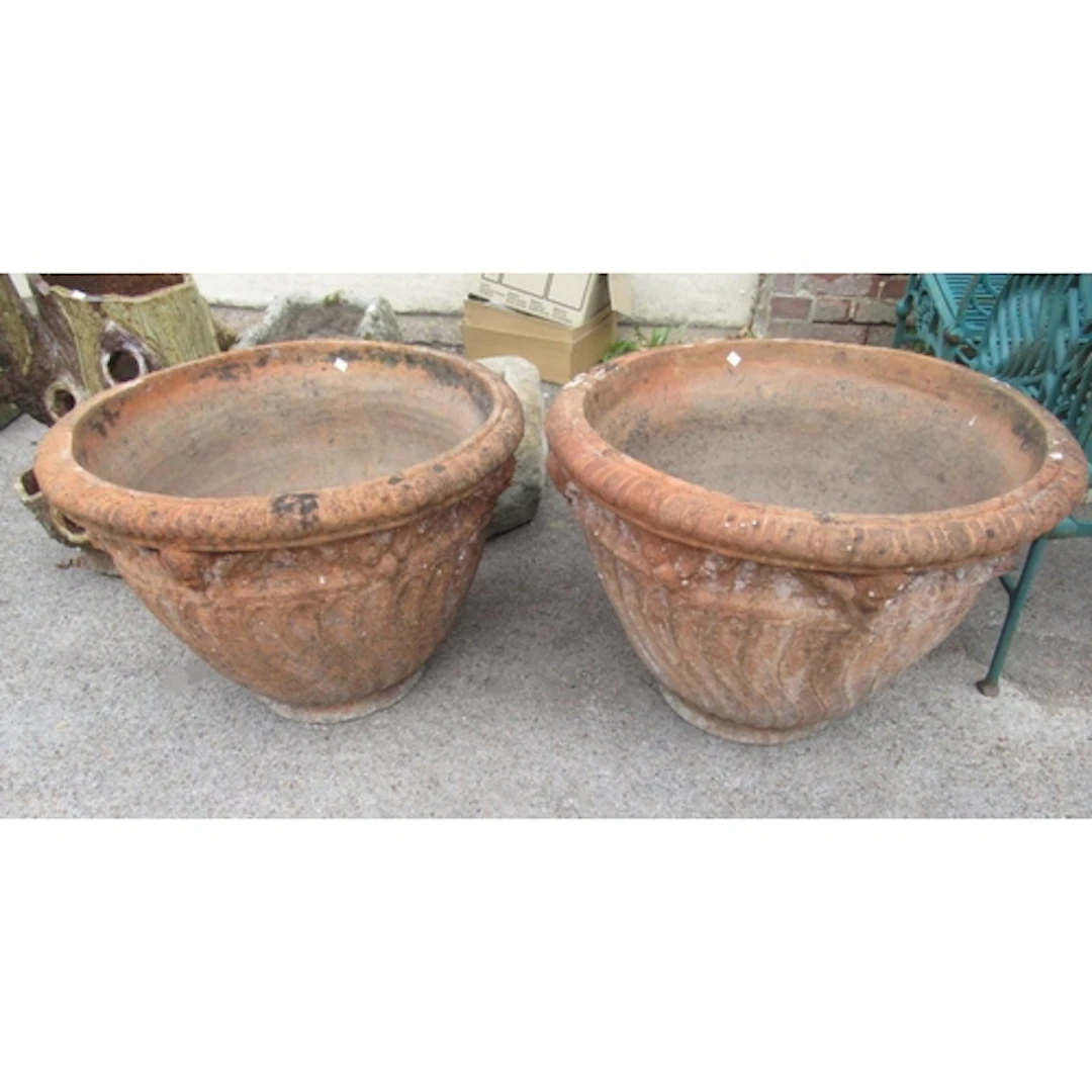 Pair of large terracotta weathered circular planters, with b...