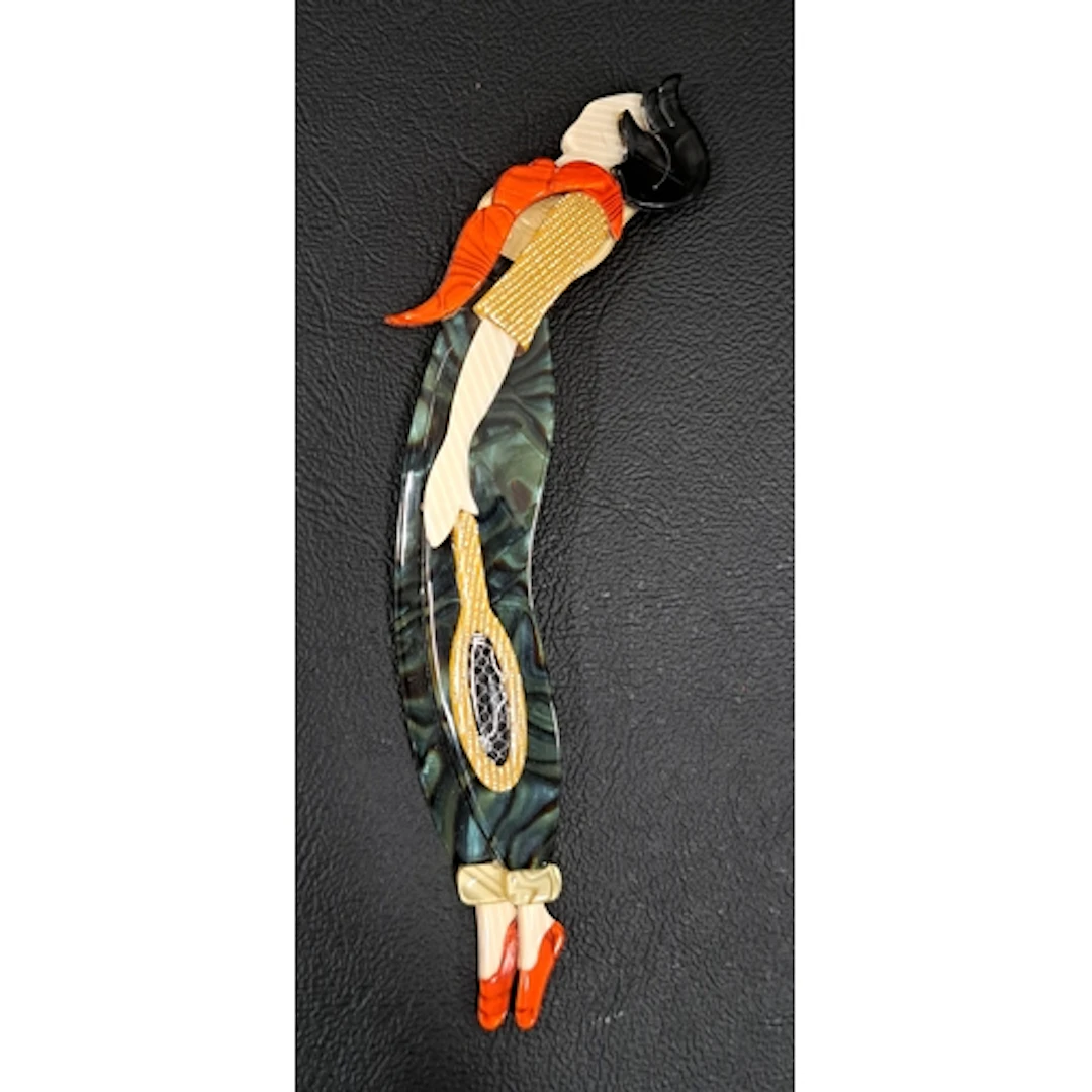LEA STEIN TENNIS PLAYER BROOCH with green trousers, orange s...