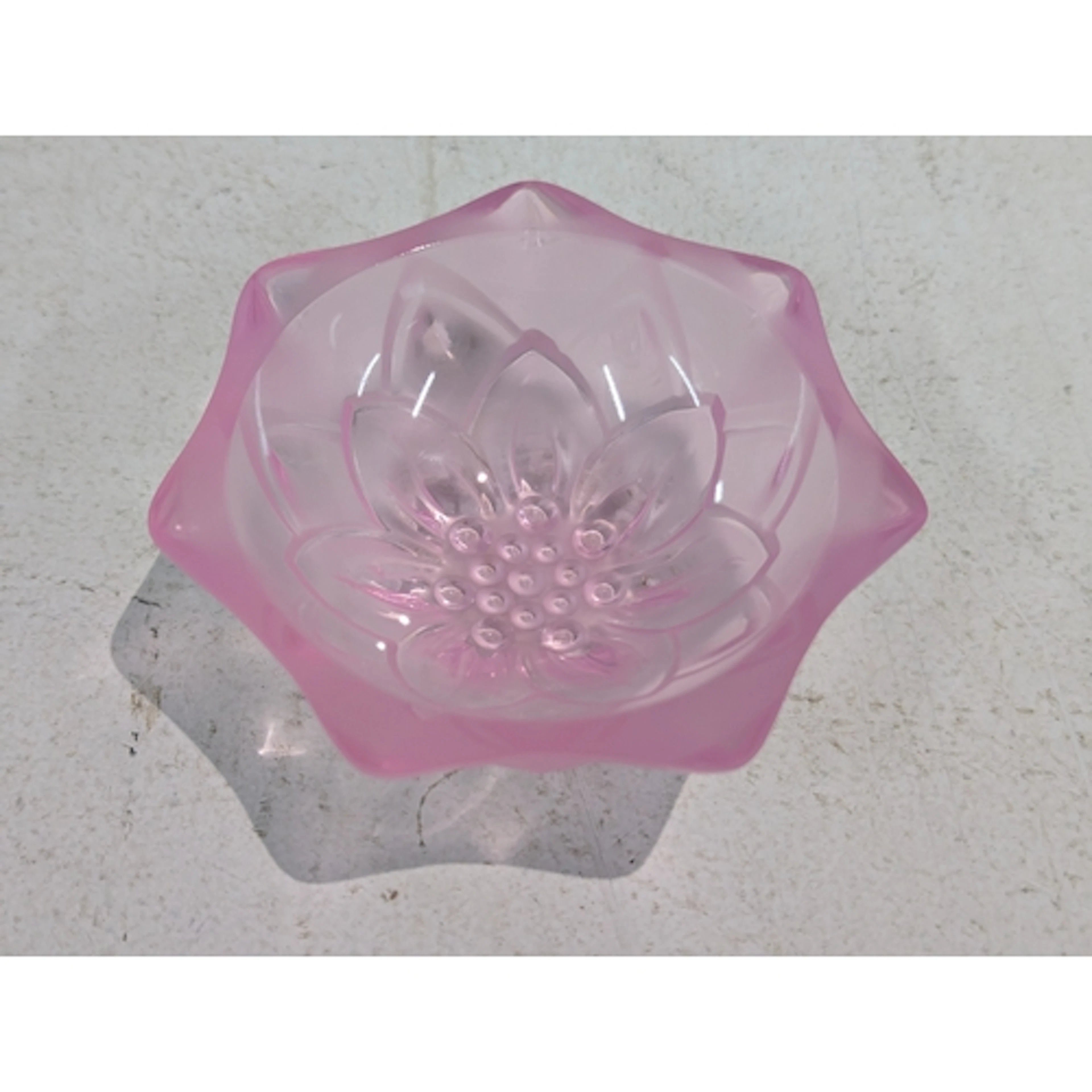 A pink coloured glass Lalique 'Nymphea' small dish of heptag...