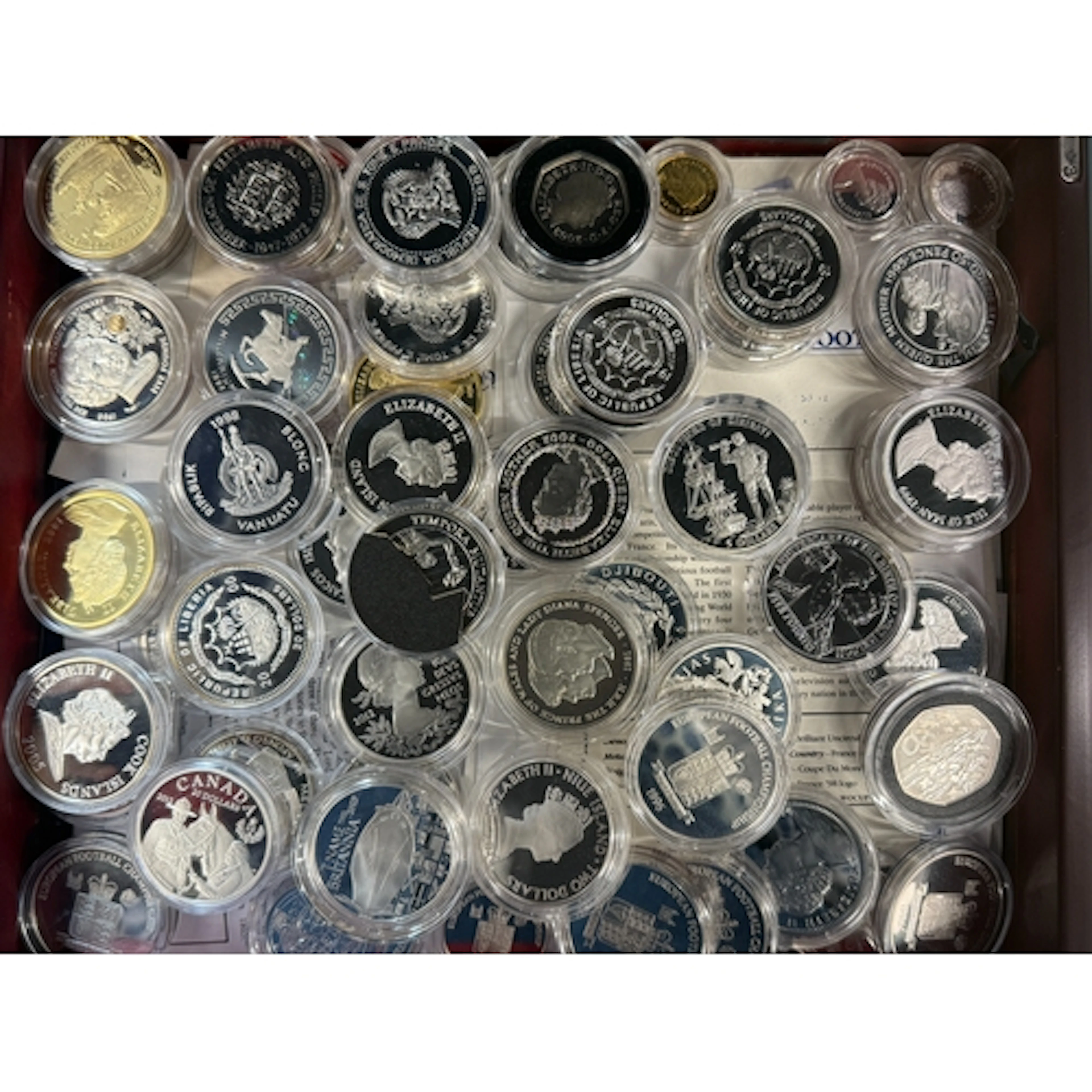 A collection of 61 World silver proof commemorative coins, m...