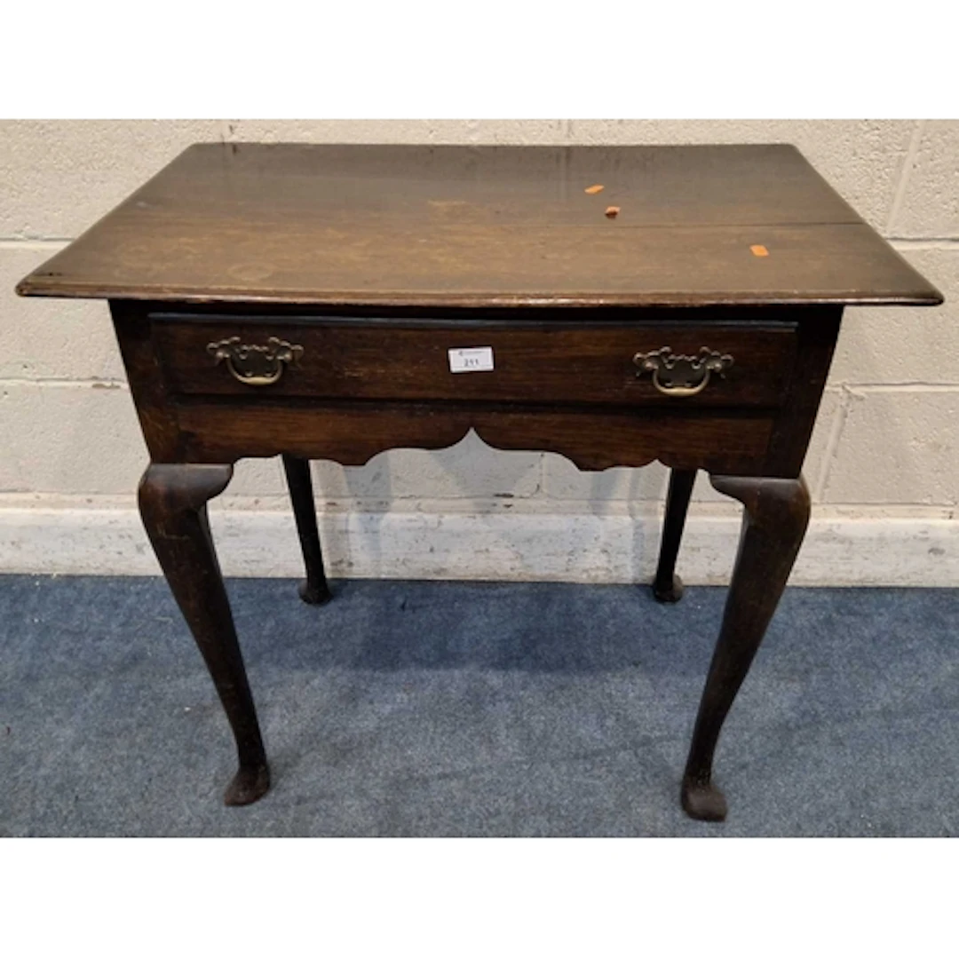 A GEORGIAN OAK LOWBOY, fitted with a single frieze drawer, r...