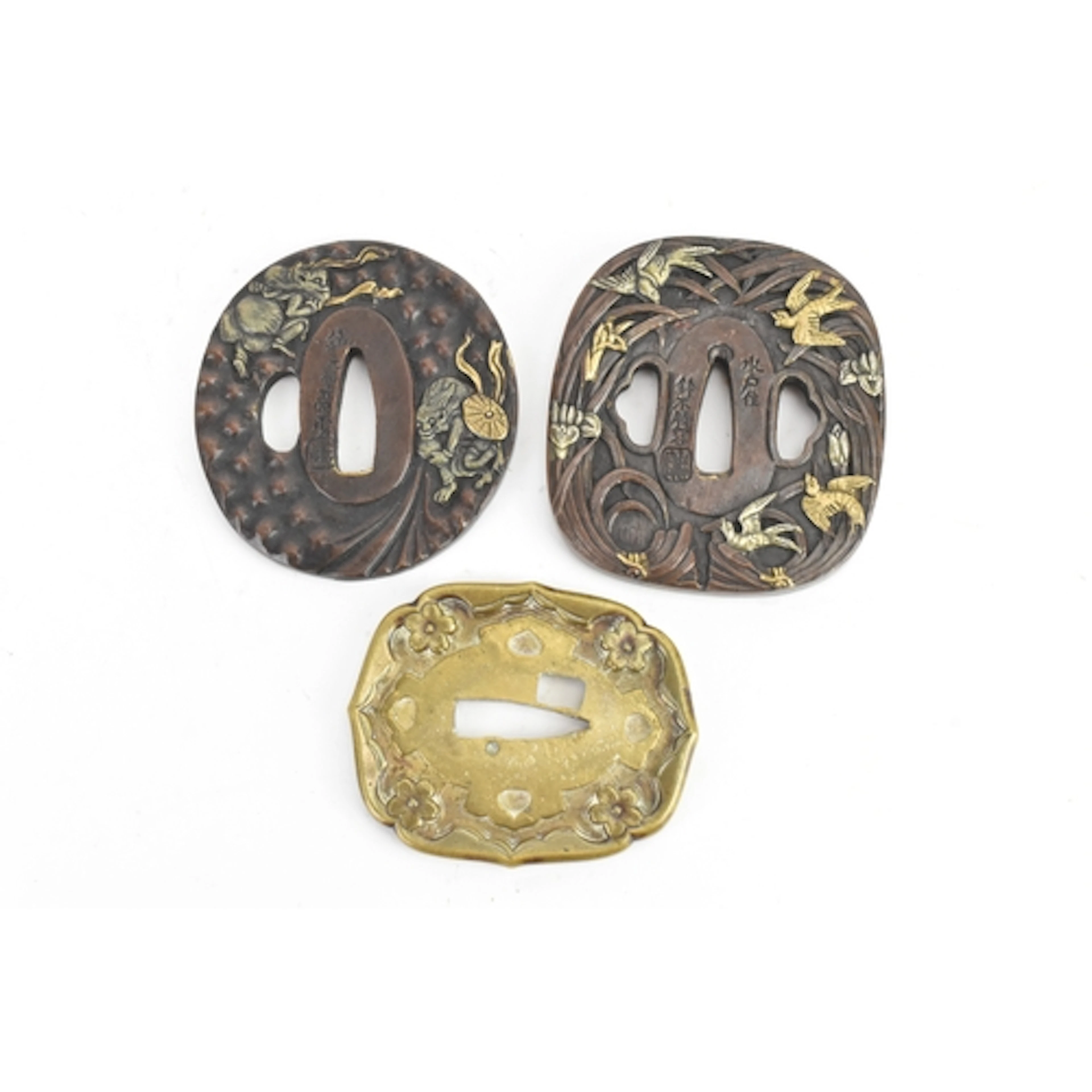 Three Japanese sword guards (tsuba), of various rounded form...