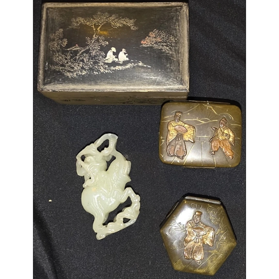 A Chinese jade coloured carving of a monkey riding on the ba...