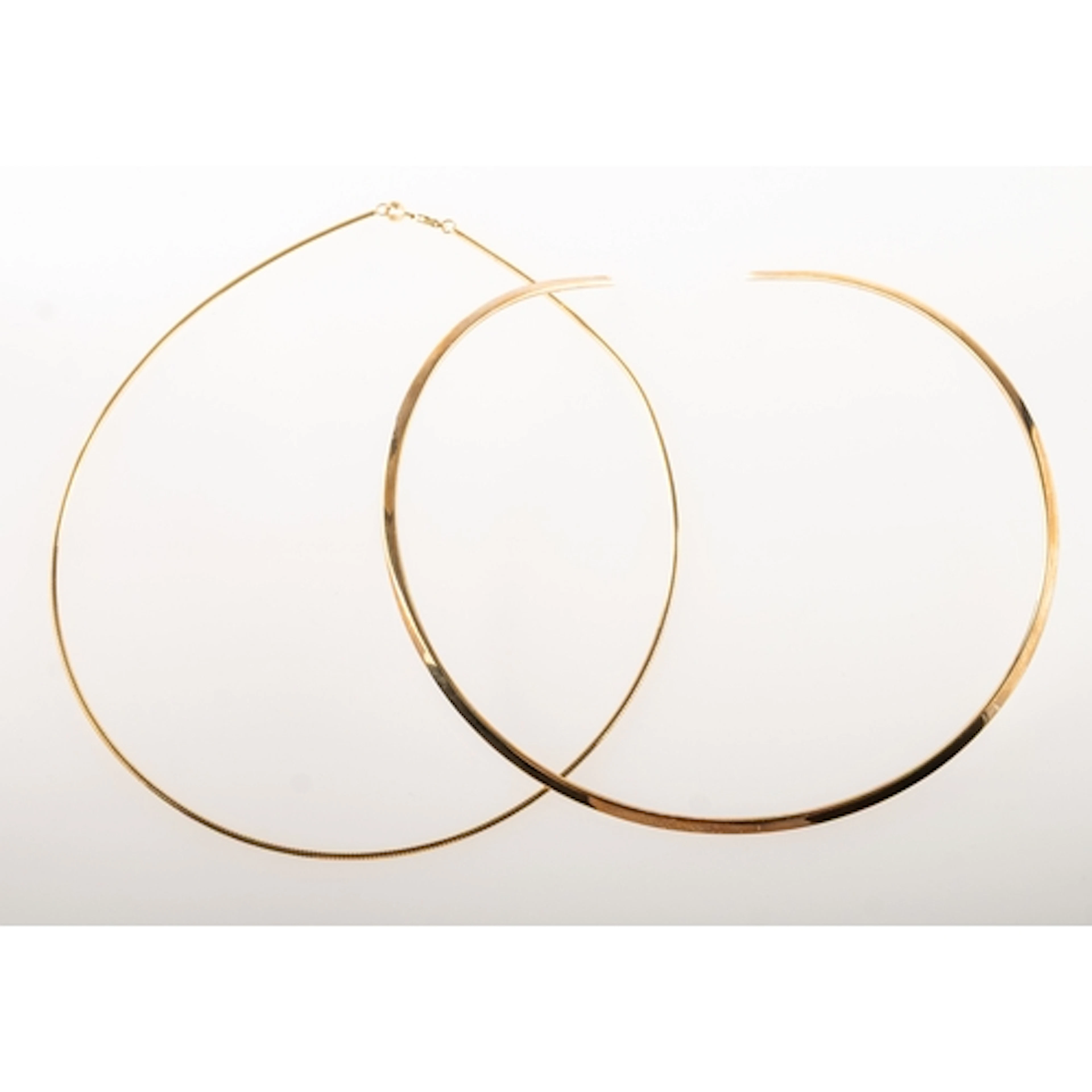 Two 9ct gold collar necklaces of varied design, including a ...