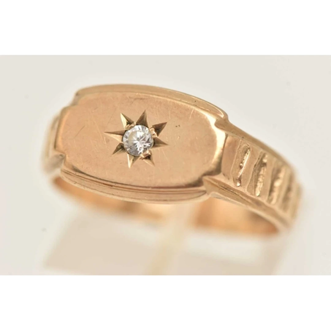 A 9CT GOLD GEM SET RING, star set with a colourless paste, t...