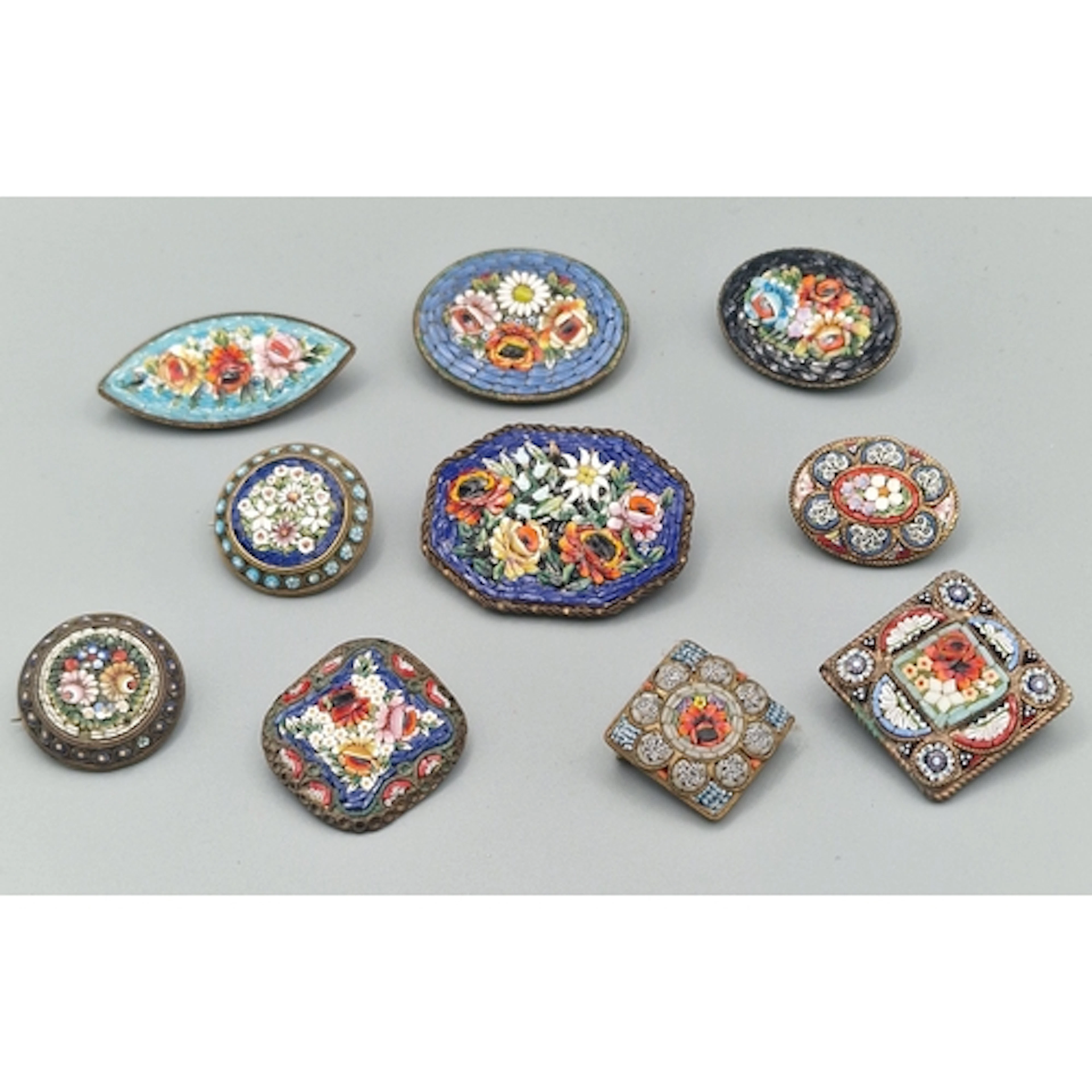Collection of Italian micro mosaic floral and gilt brooches....