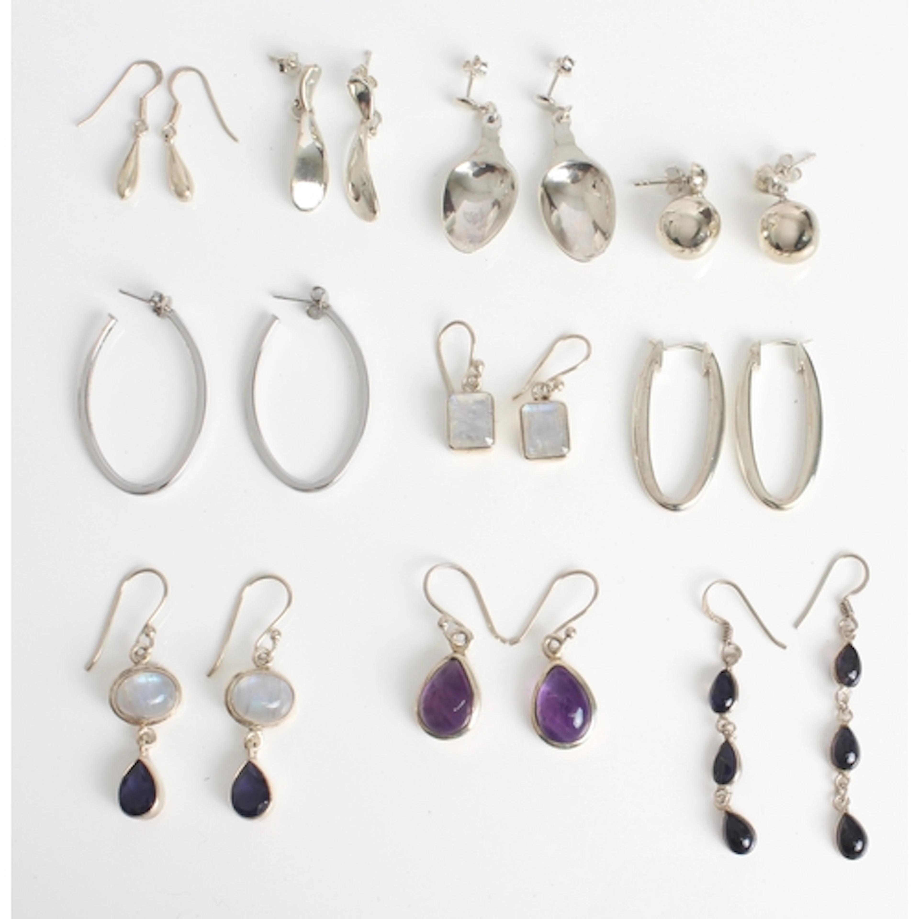Ten pairs of sterling silver earrings, some set with gemston...