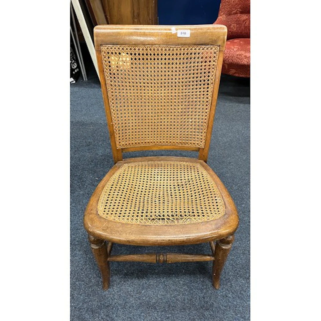 Antique bergere bedroom chair raised on splayed supports.