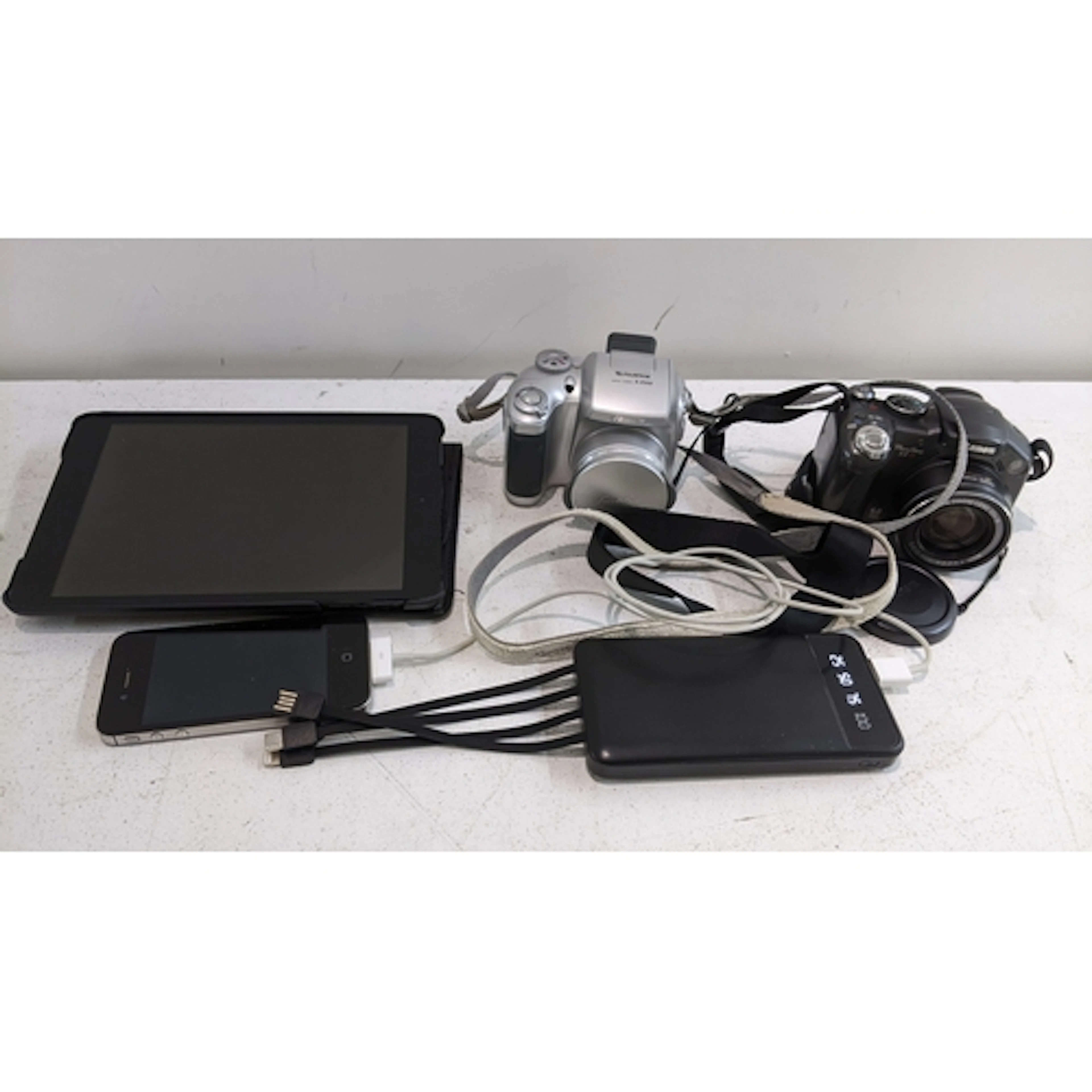 Two digital cameras, one Yamaha, an iPad mini, an iPhone 4, ...