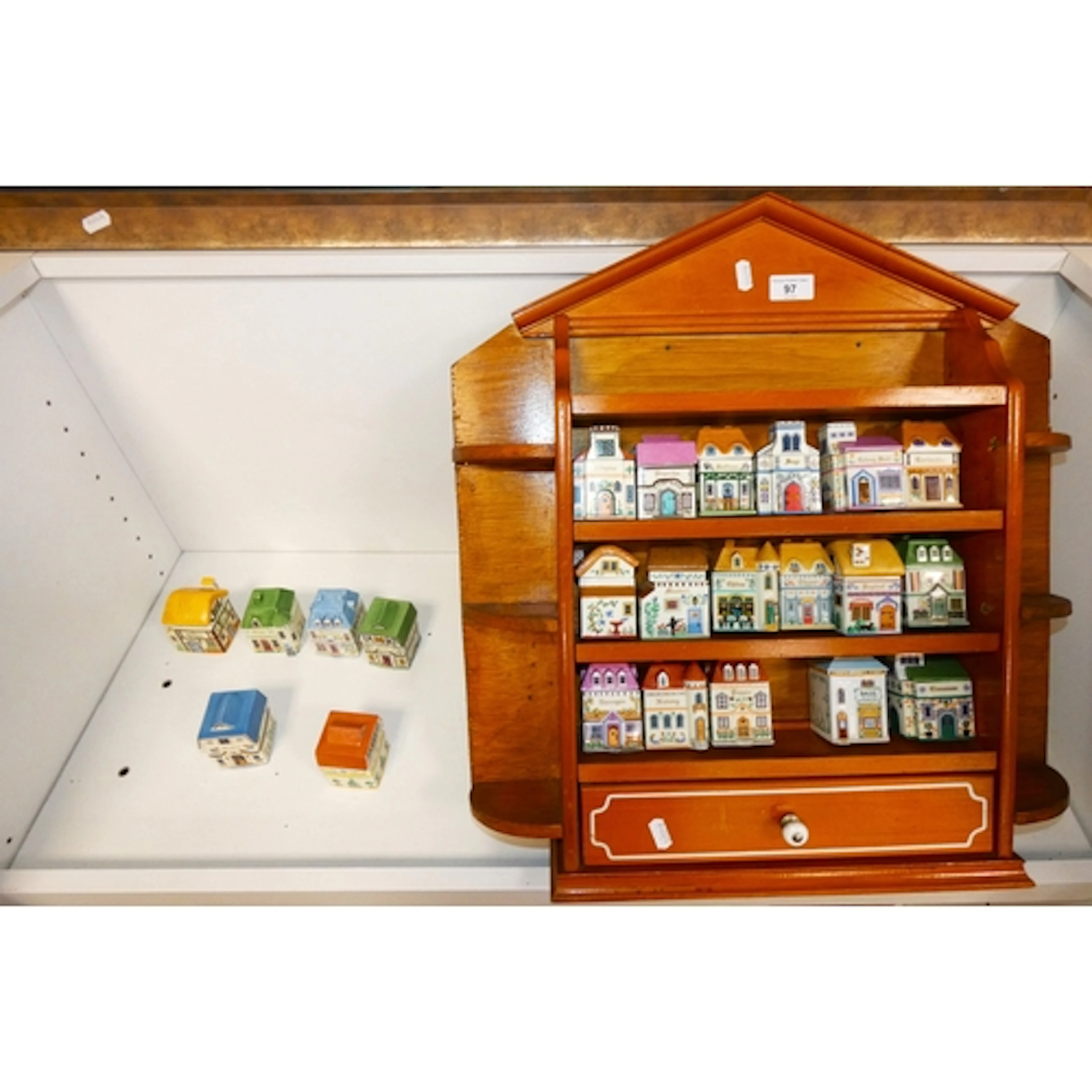 Collection of ceramic spice jars modelled as houses, with di...