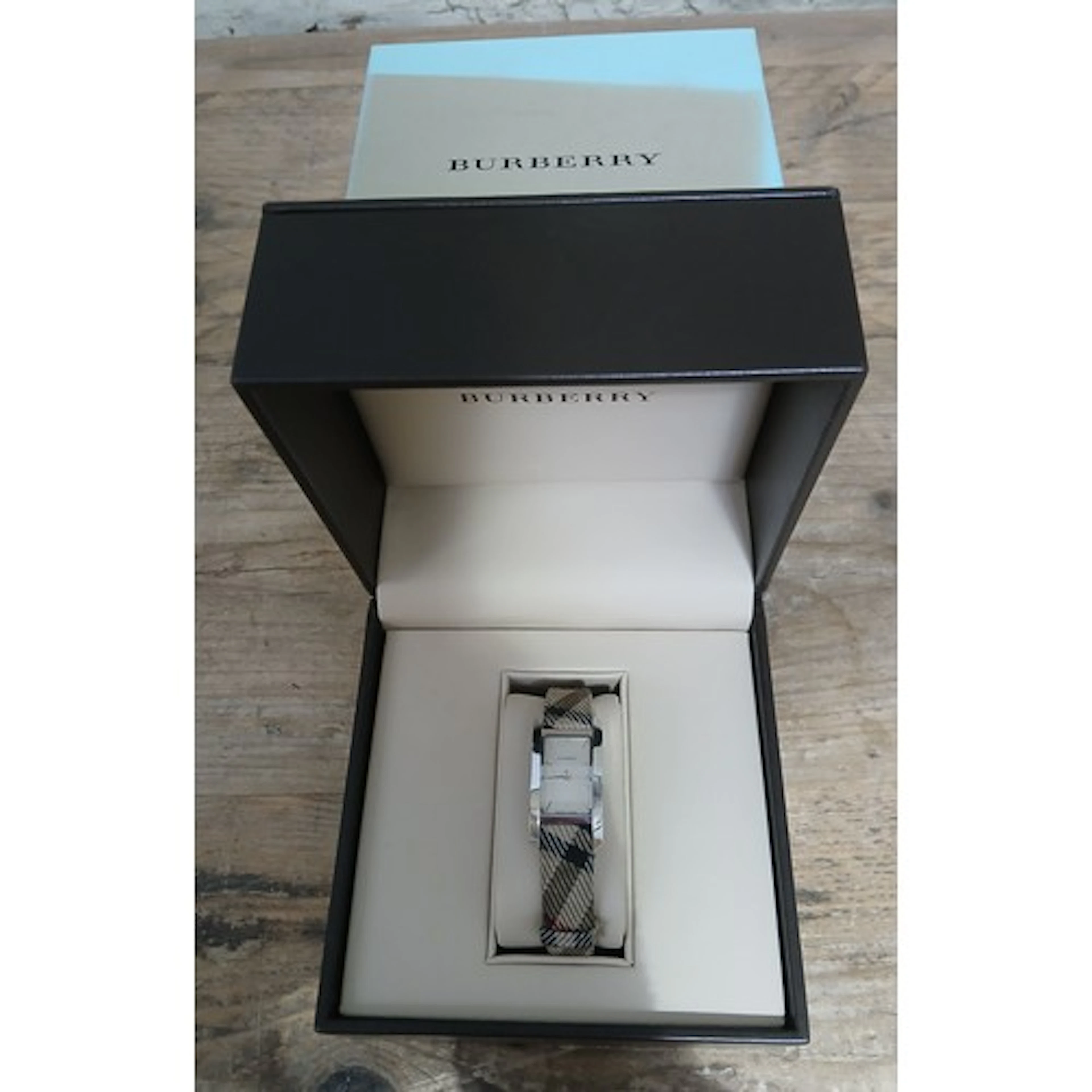 A Burberry watch, tartan strap, boxed with papers.