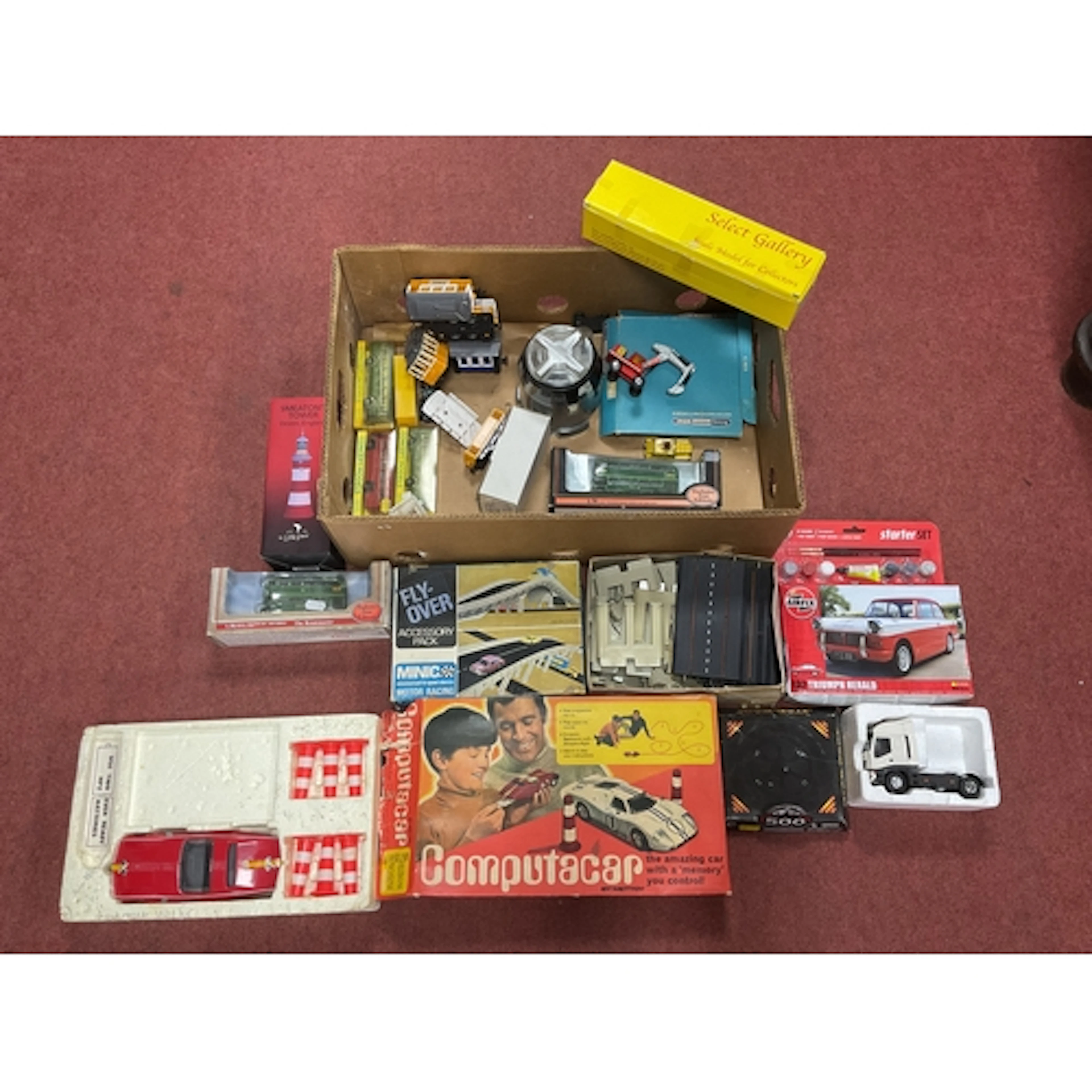 An assorted collection of diecast model vehicles, plastic mo...