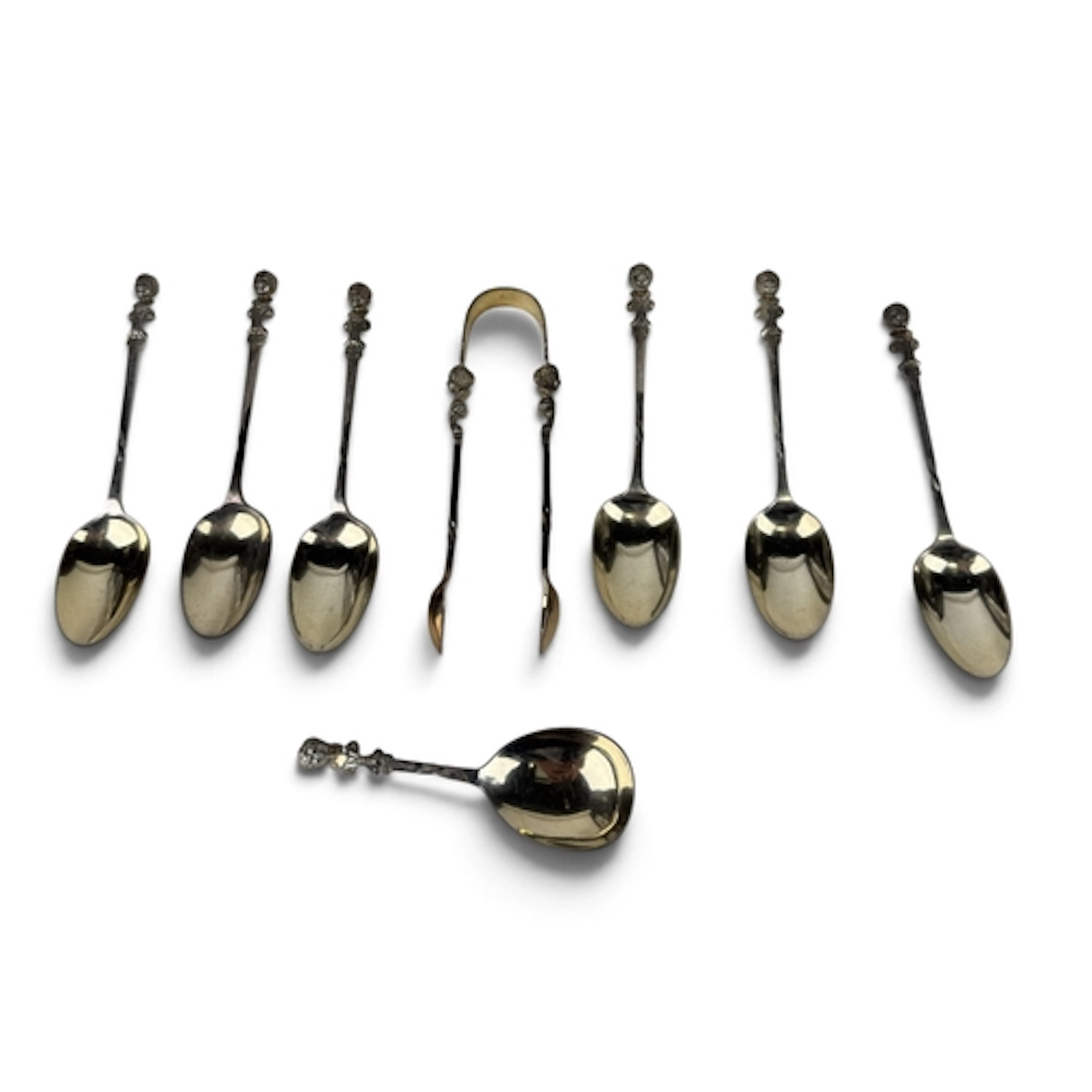 A SET OF SILVER TEASPOONS AND SUGAR TONGS WITH ANGEL HEAD FI...