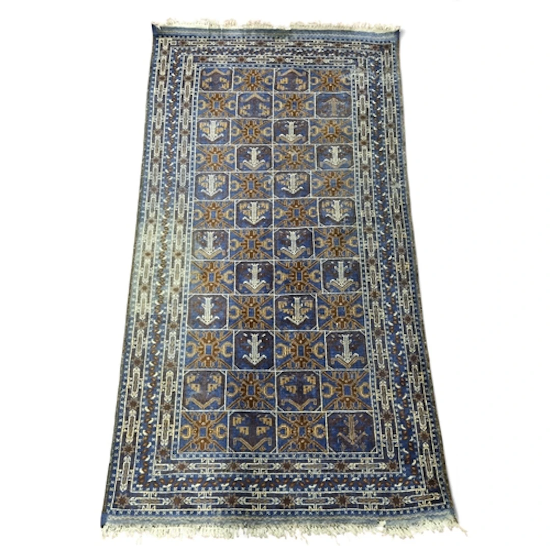 A blue ground Persian Rug with repeating central medallion d...