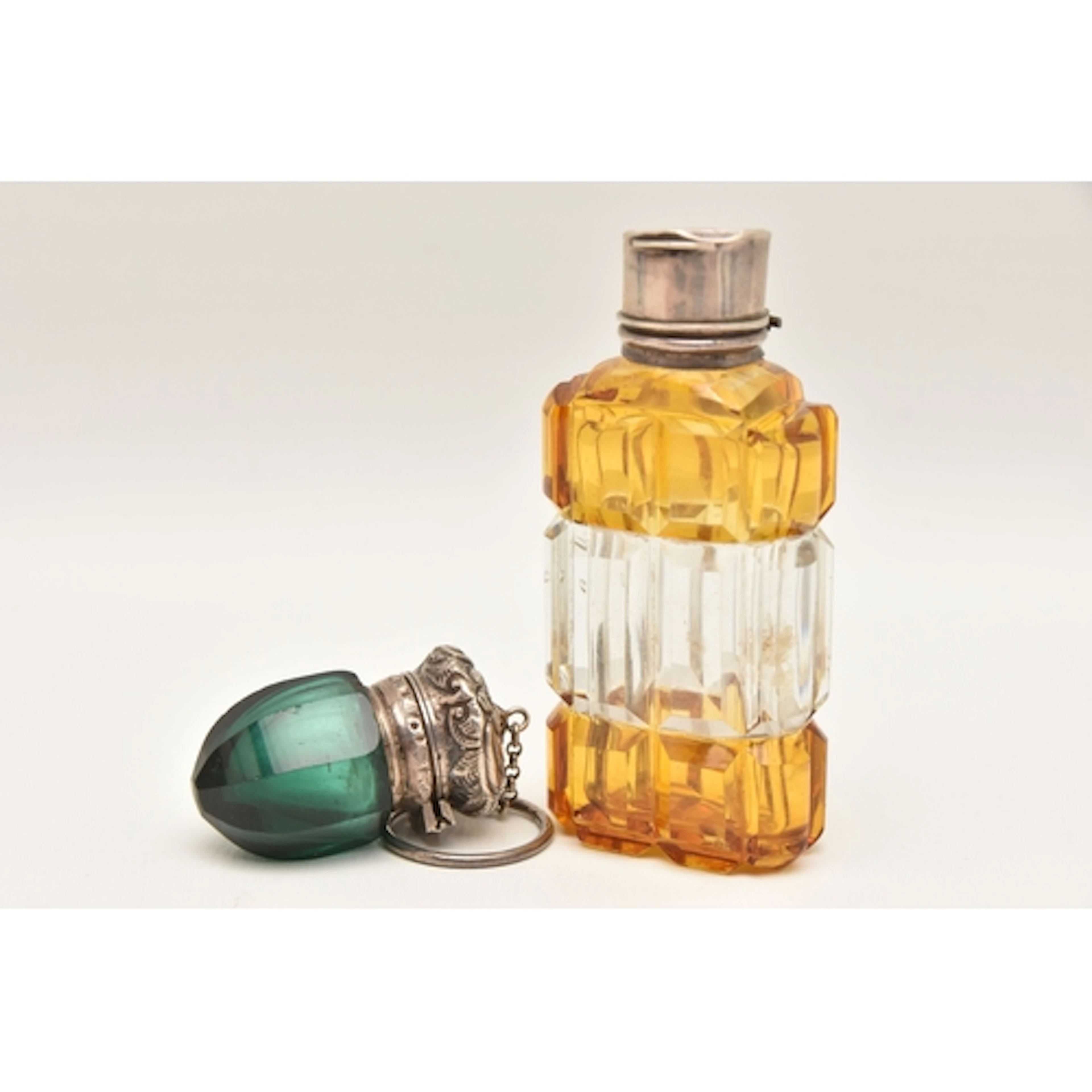 TWO GLASS SCENT BOTTLES, the first with cut yellow and clear...