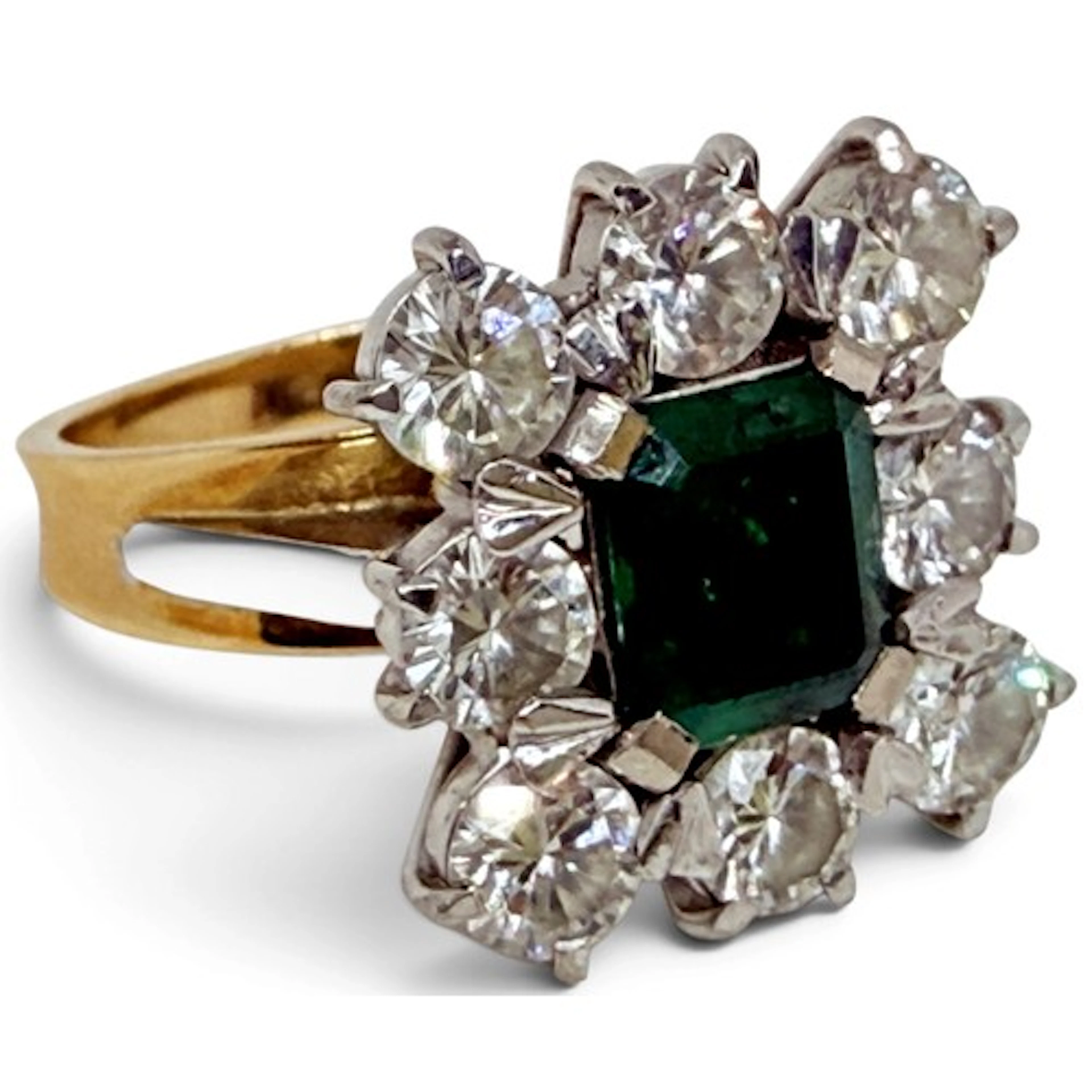 An emerald and diamond dress ring, centred with an emerald-c...