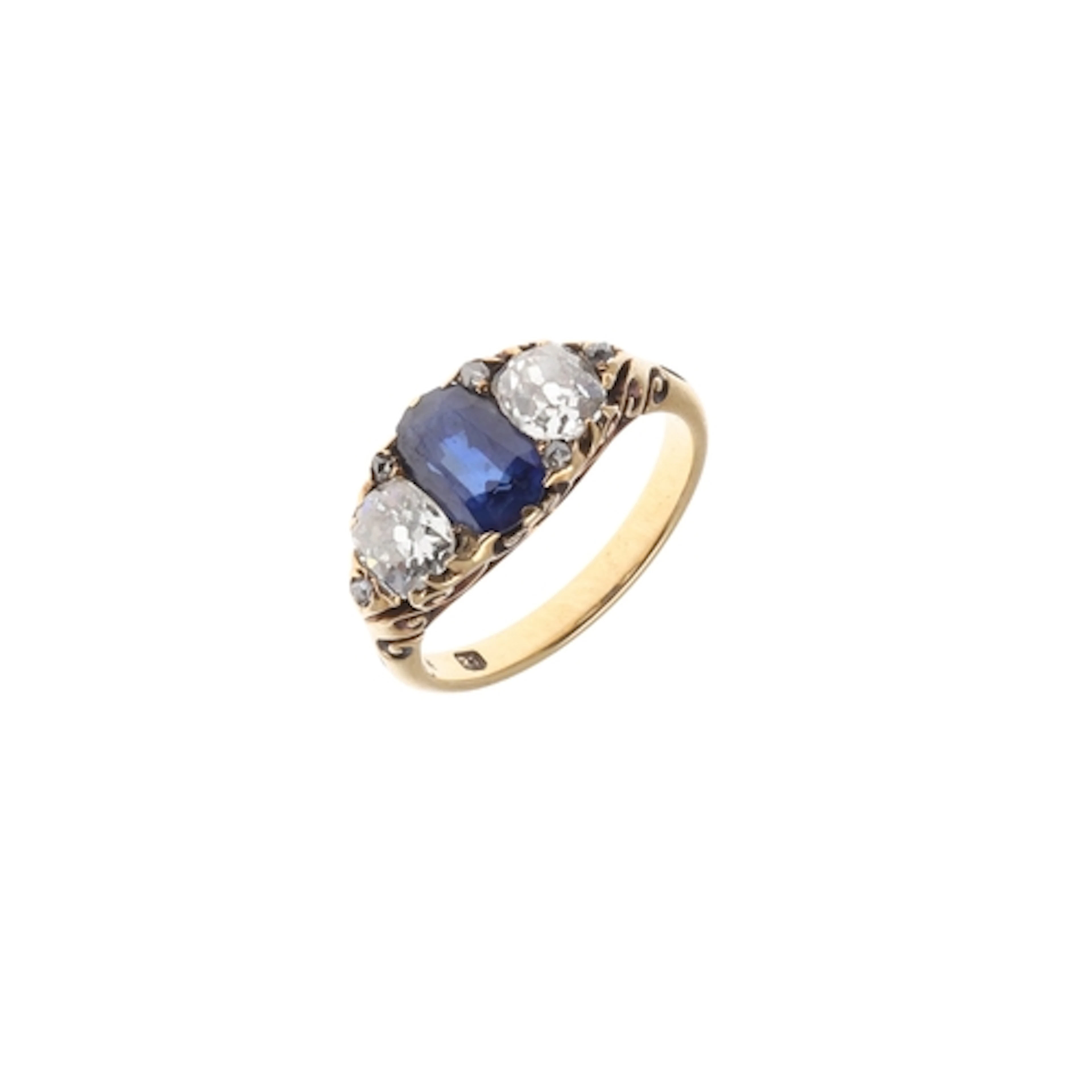A SAPPHIRE AND DIAMOND THREE STONE RING. the oval-shaped sap...