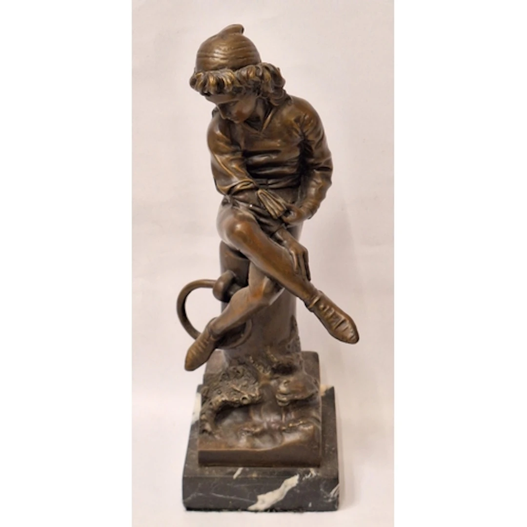 Bronze Sculpture Young Man sitting on a tree trunk in the st...