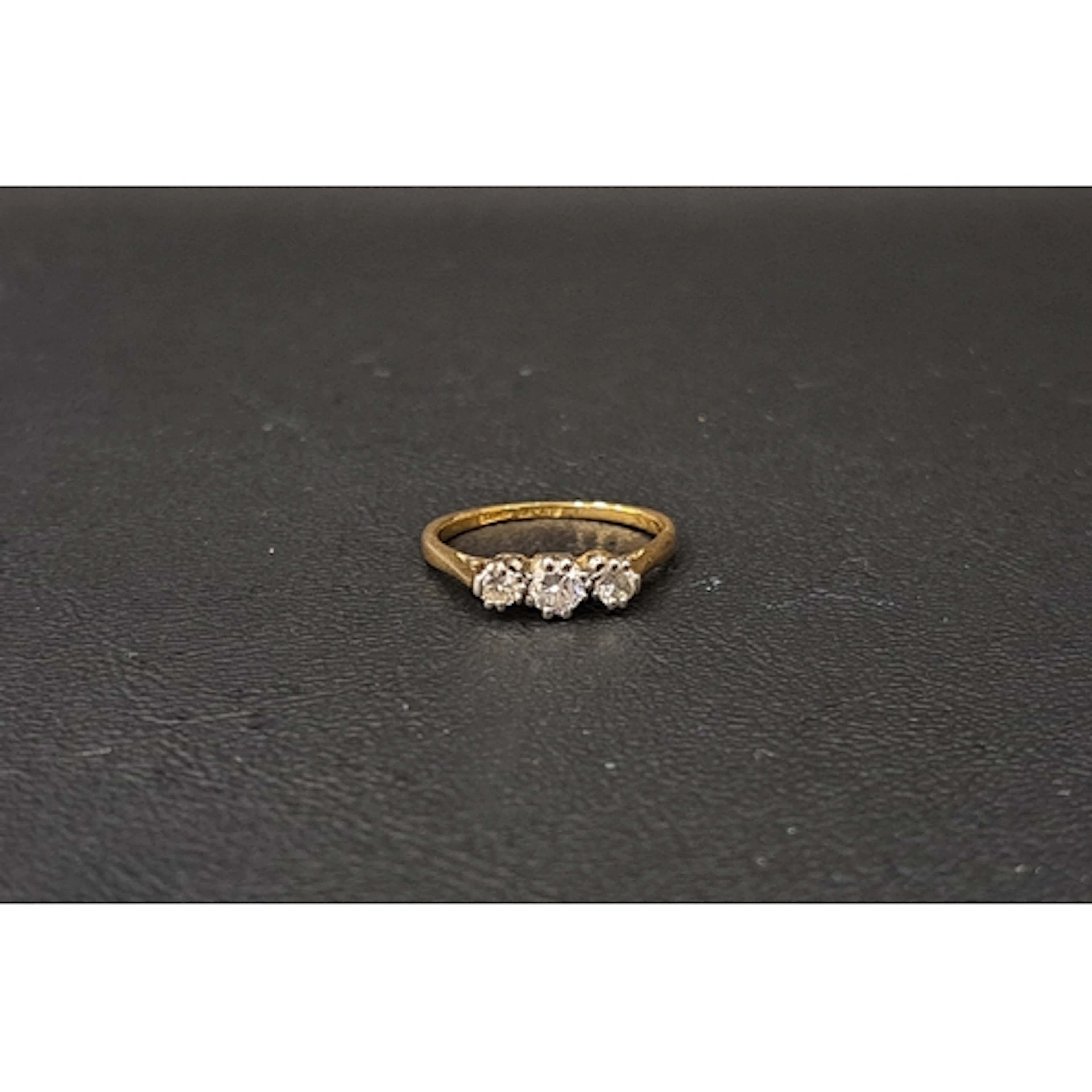 GRADUATED DIAMOND THREE STONE RING the round brilliant cut d...