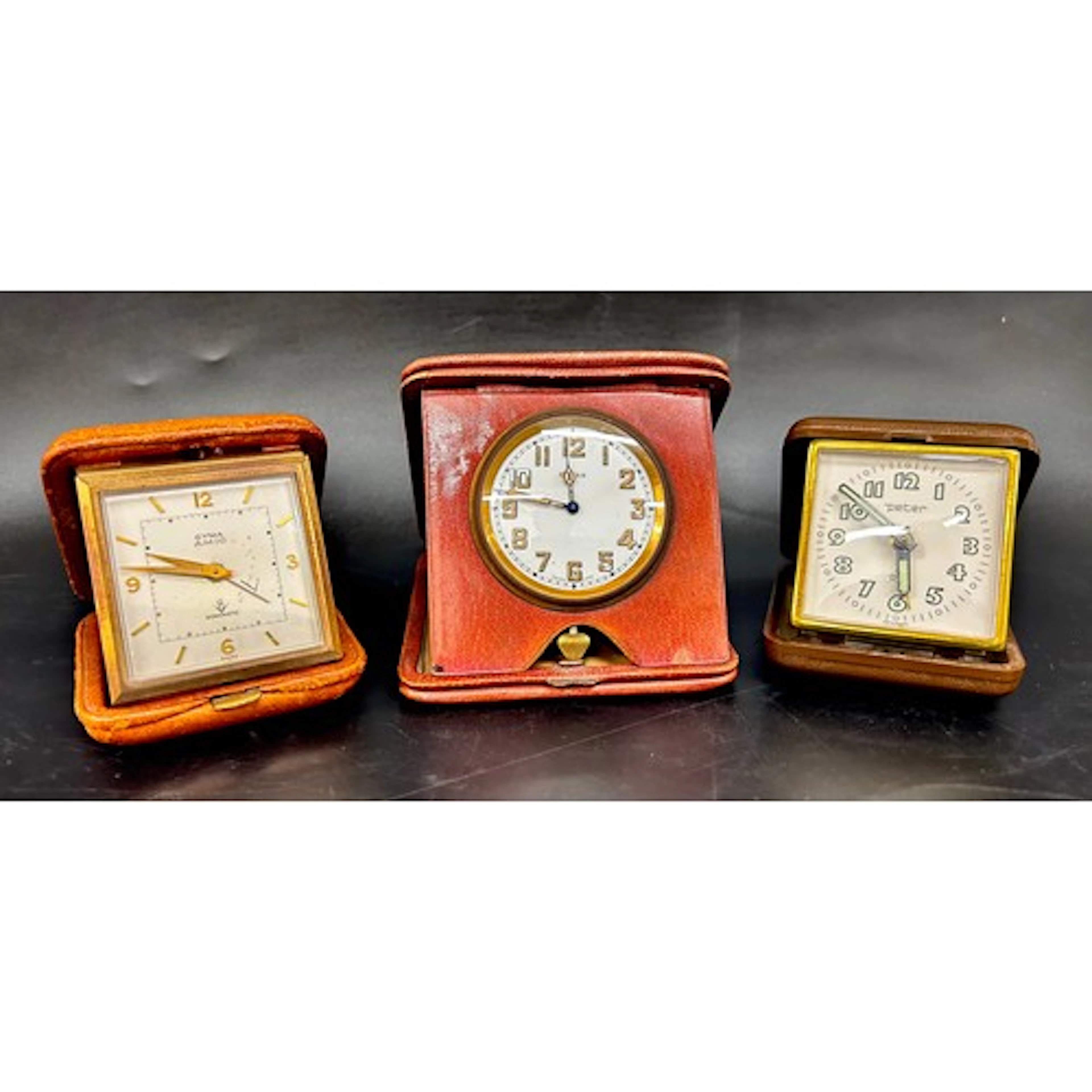 An 8-Days clock in a leather case, an 8-Days Cyma Amic clock...