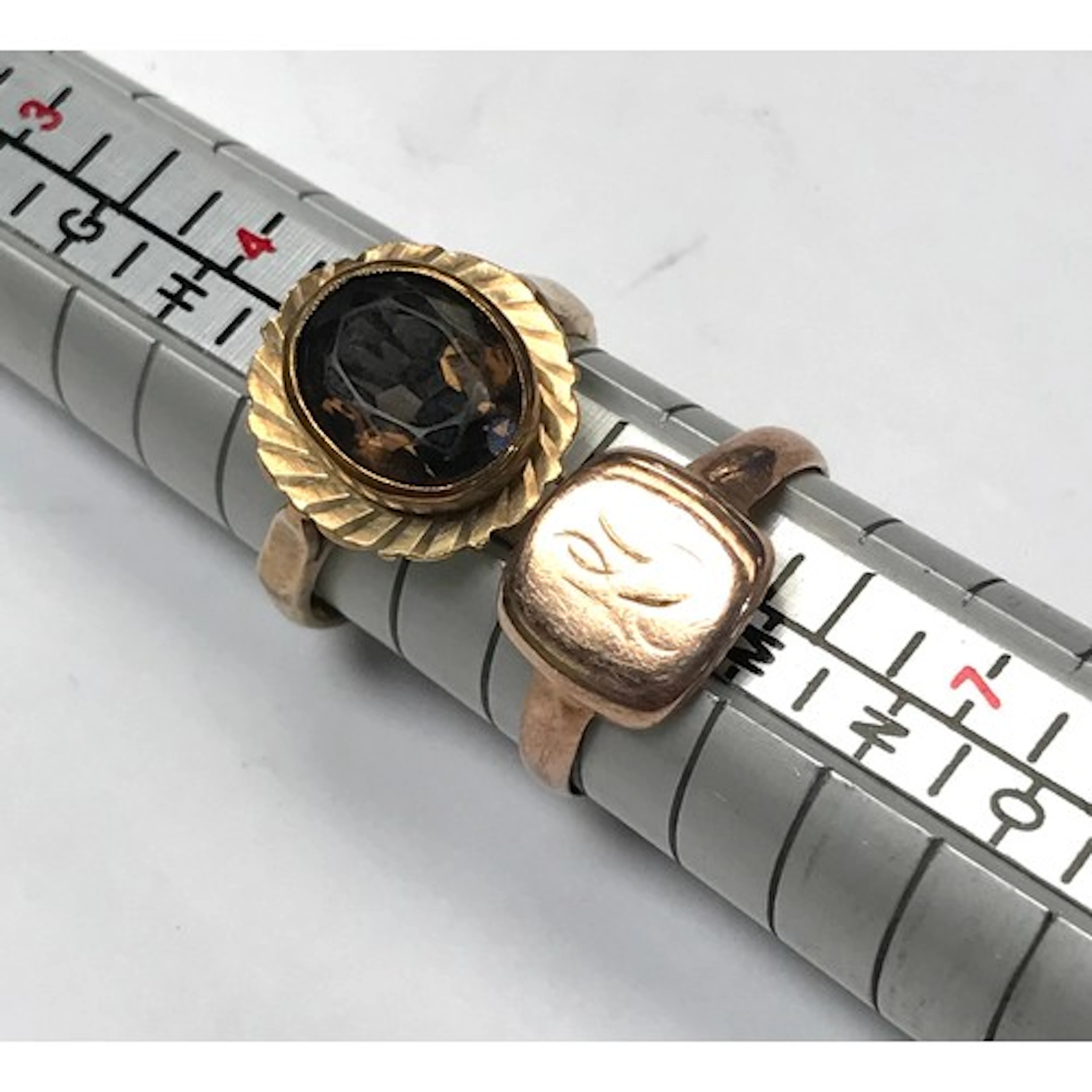 A 9ct gold ring set with an oval smoky quartz; a 9ct gold si...