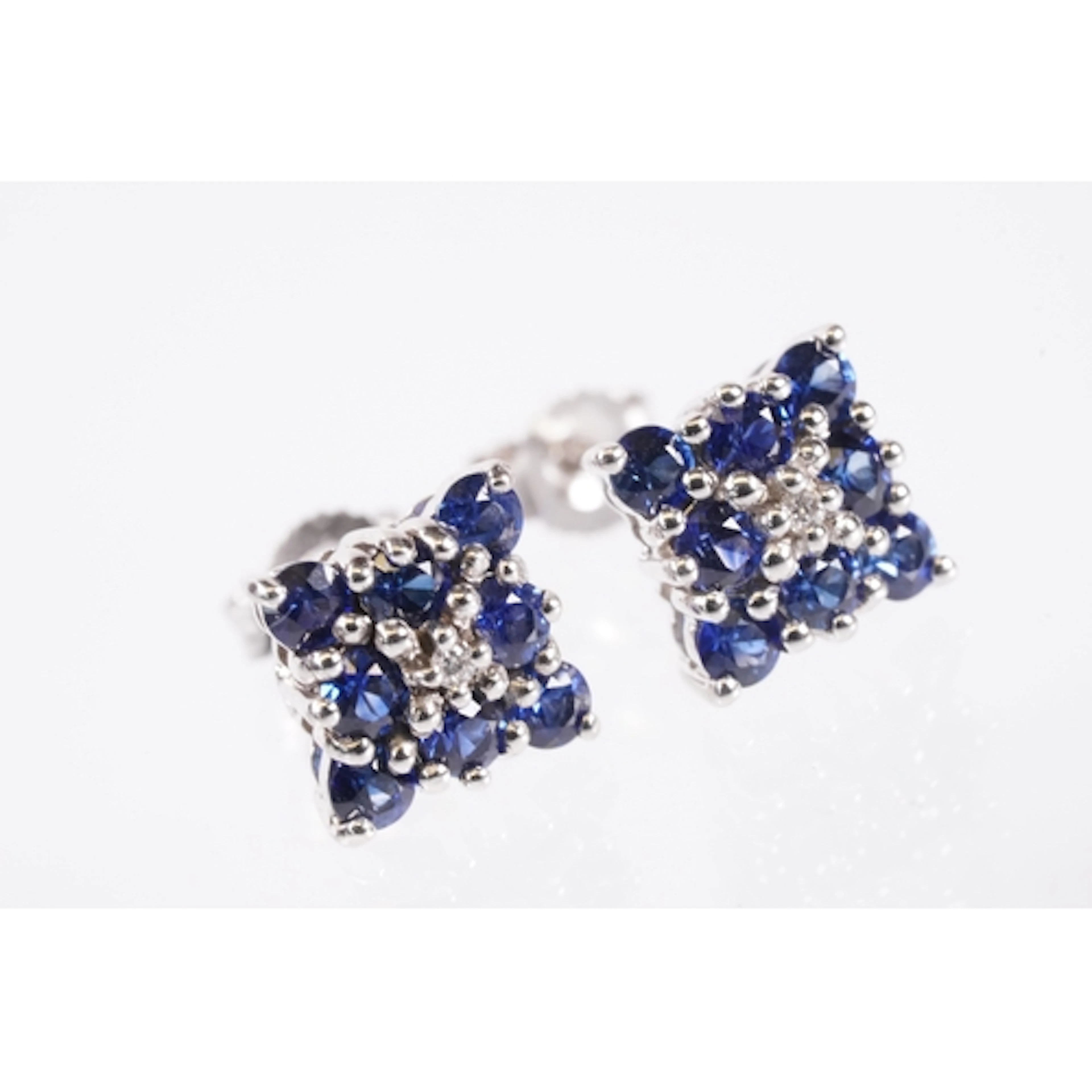9ct white gold and tanzanite cluster earrings. Each earring ...