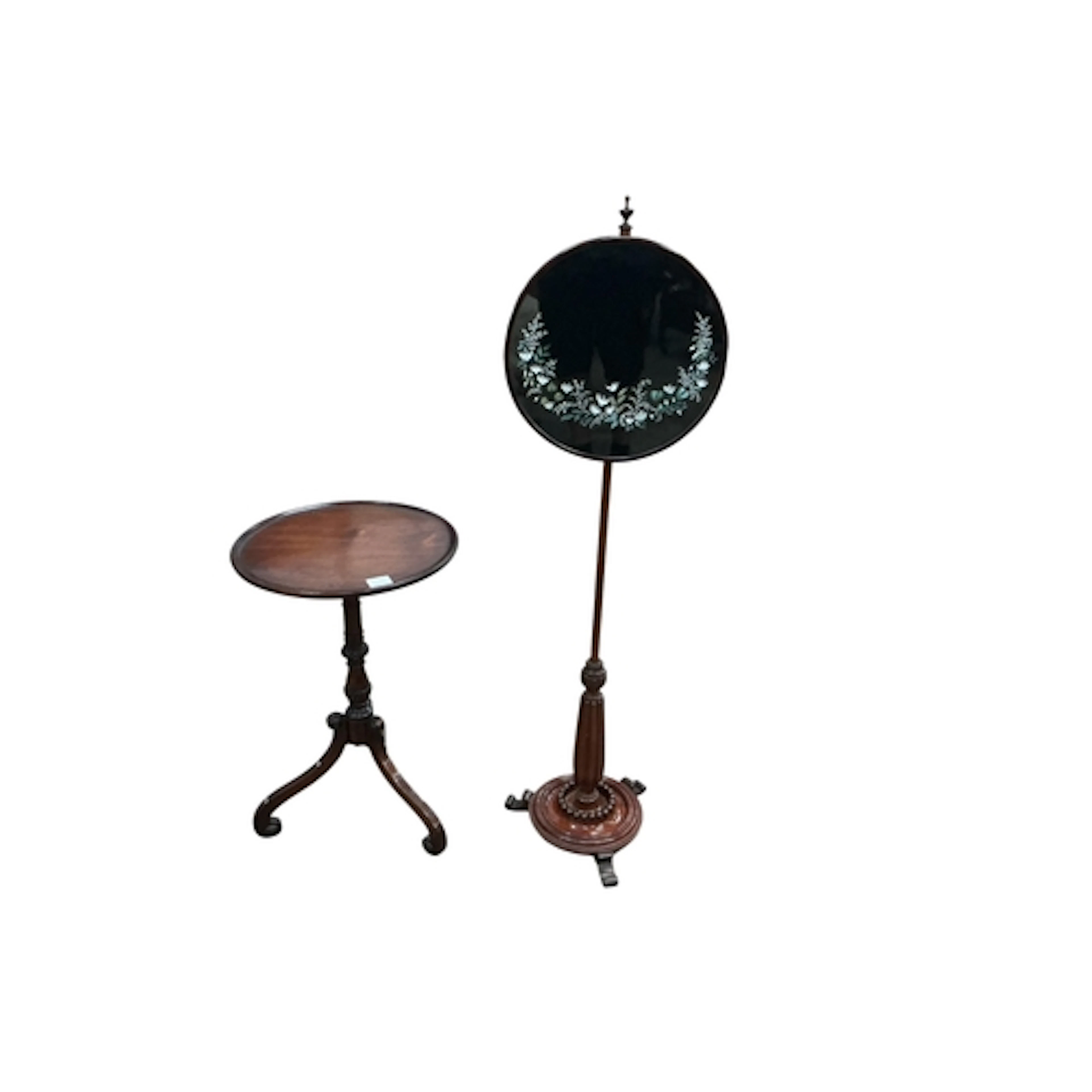 A Victorian mahogany pole screen and a mahogany tripod table...
