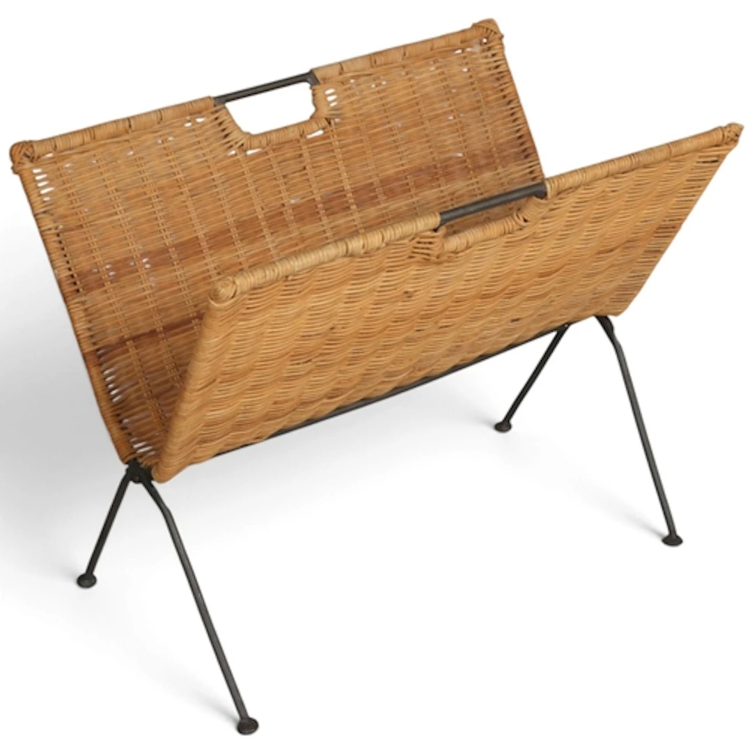 A mid-century rattan weave magazine rack on blackened metal ...