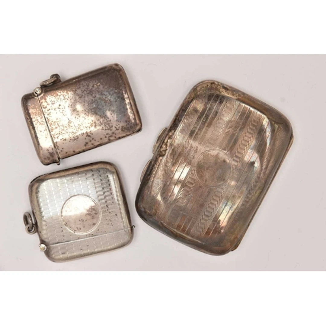 TWO SILVER VESTAS AND A CIGARETTE CASE, a square form vesta ...