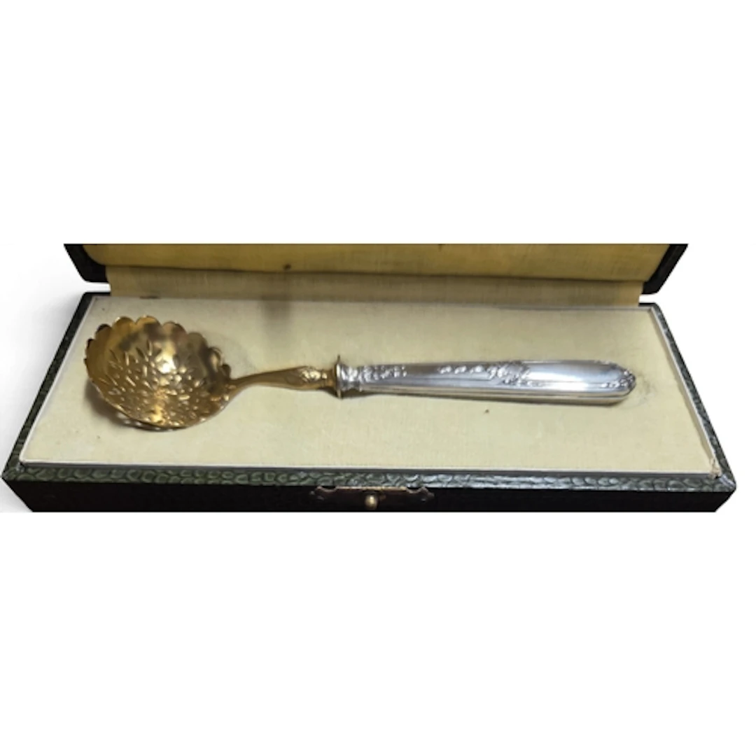 An antique cased Silver handled sugar Sifter with pierced Gi...
