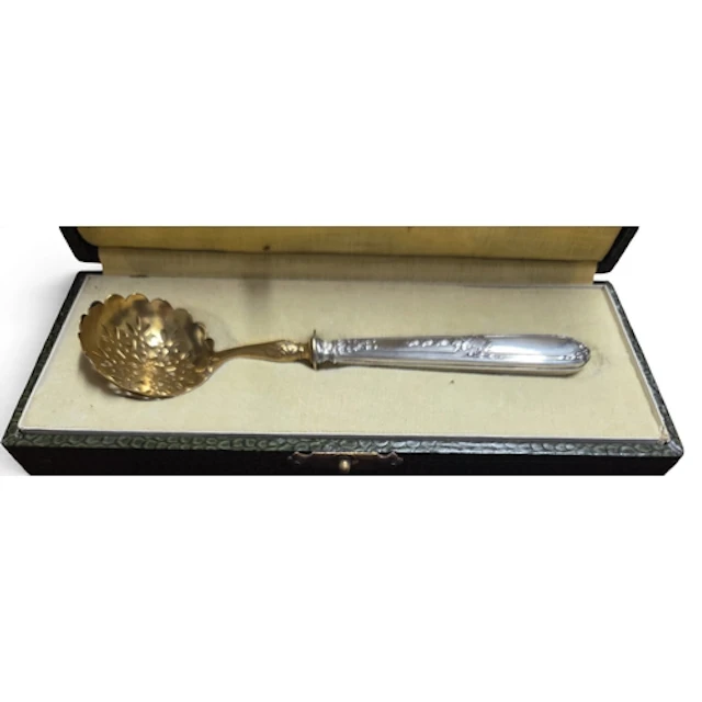 An antique cased Silver handled sugar Sifter with pierced Gi...