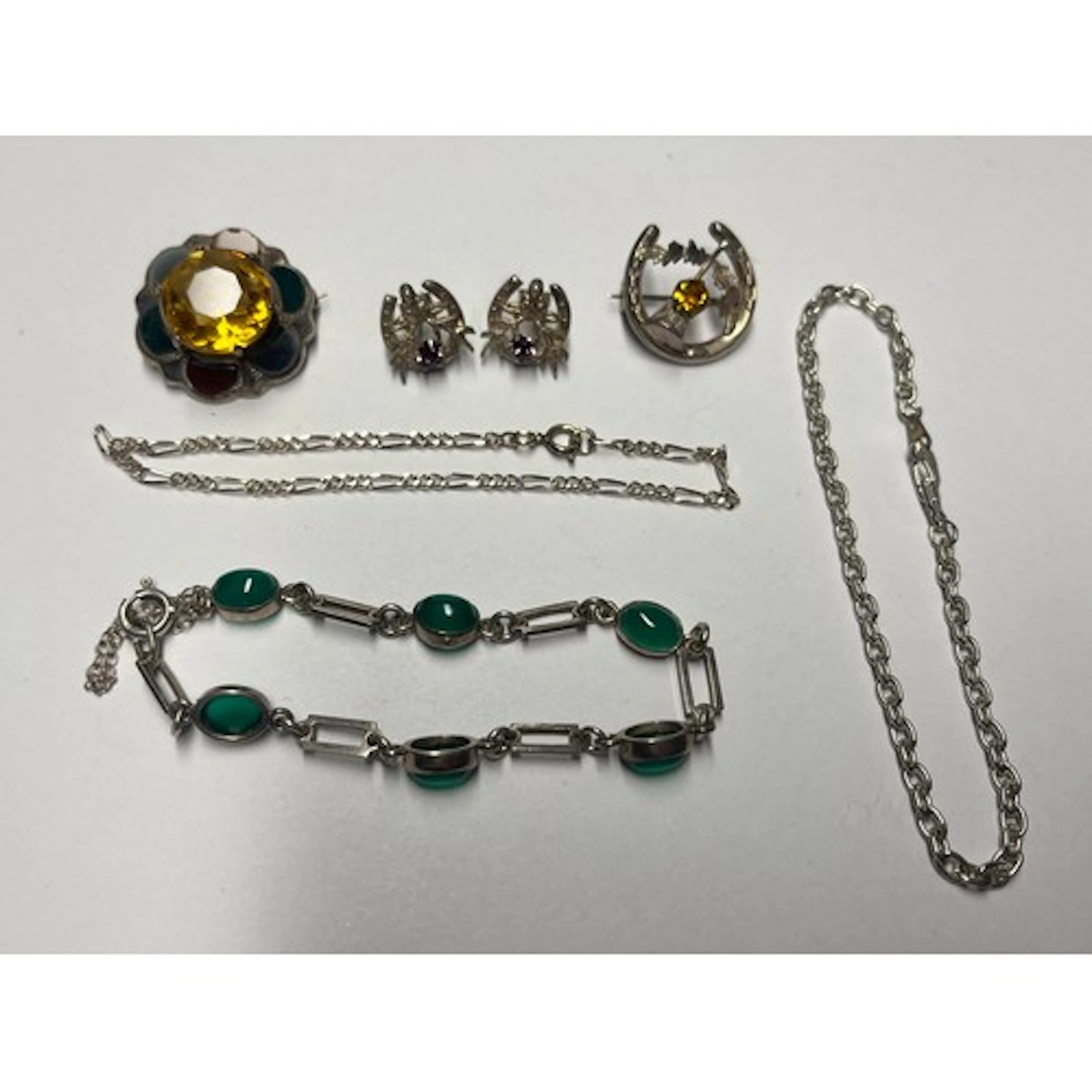 A pair of silver earrings, an agate bracelet, two silver bro...