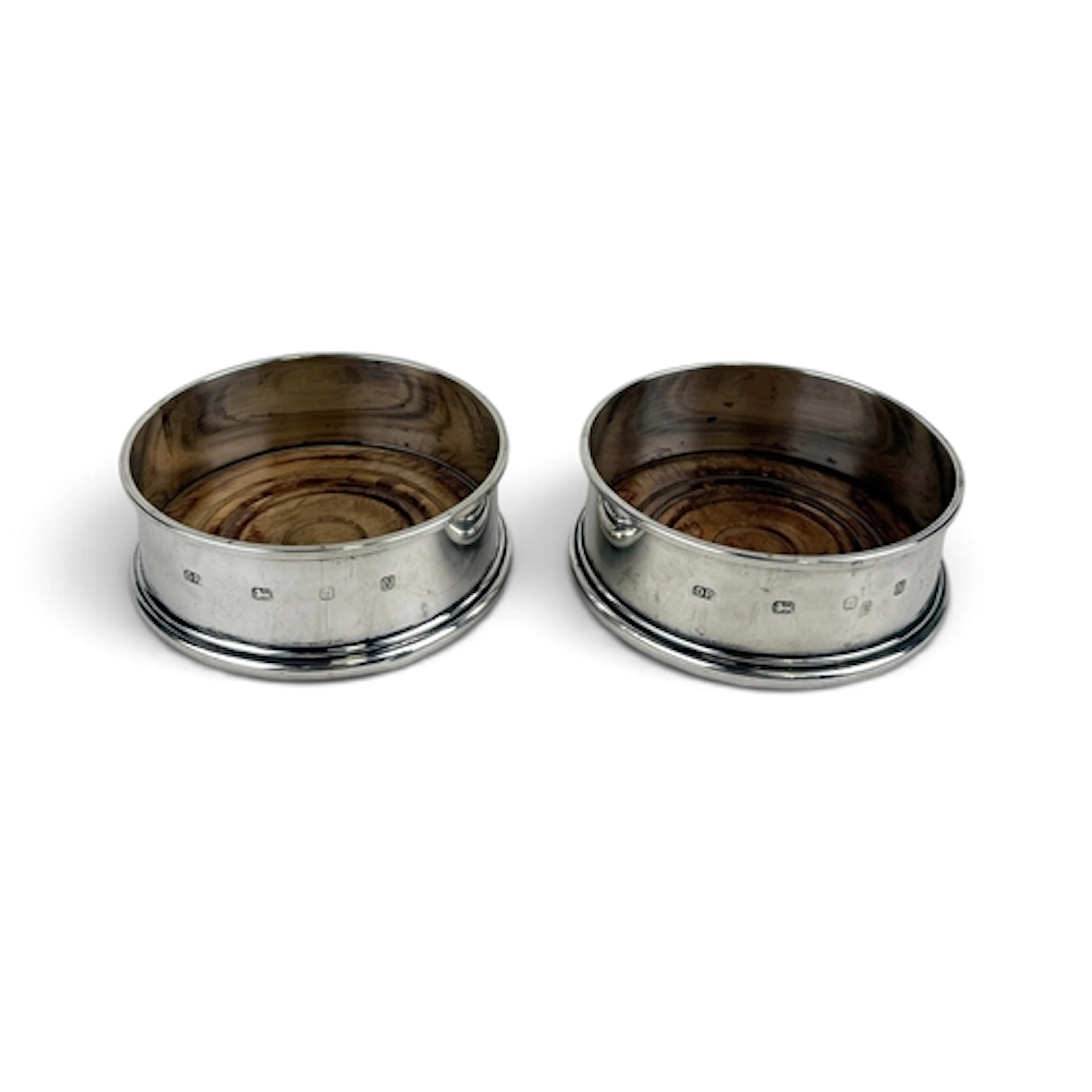 A PAIR OF REPRODUCTION GEORGE III STYLE SILVER WINE COASTERS...