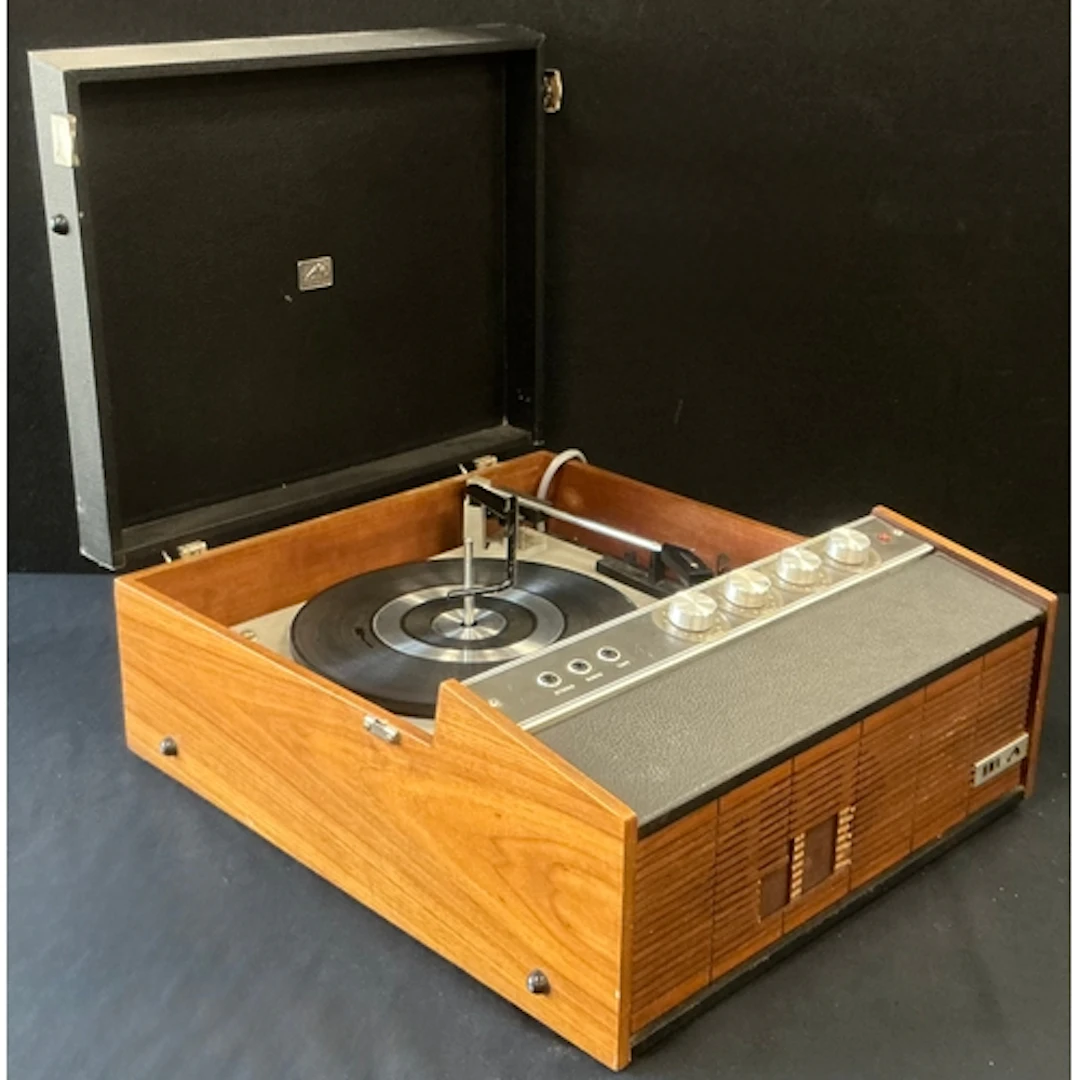 A HMV portable record player in wooden cabinet and leatheret...