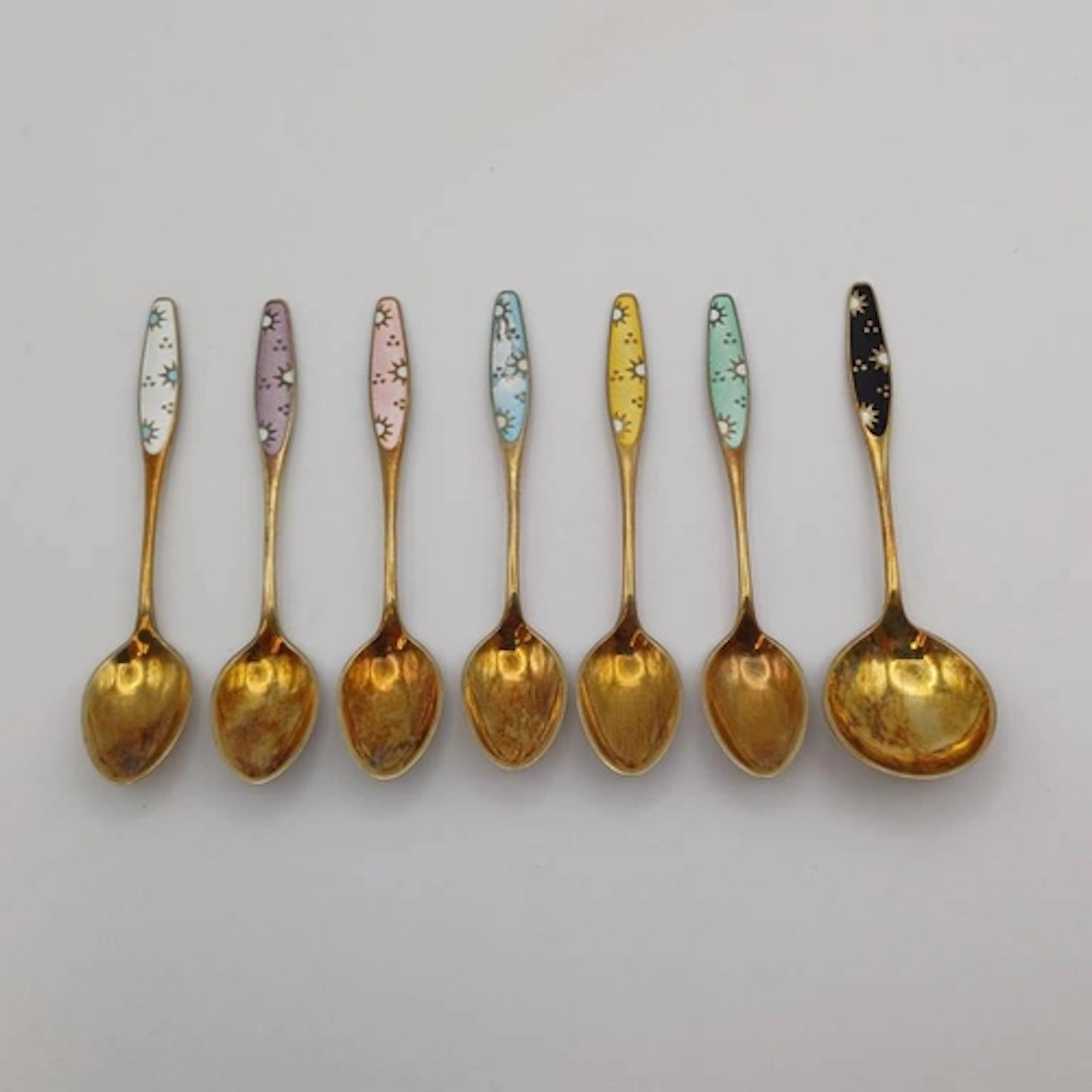 A SET OF 6 DANISH SILVER-GILT ENAMEL COFFEE SPOONS & MATCHIN...