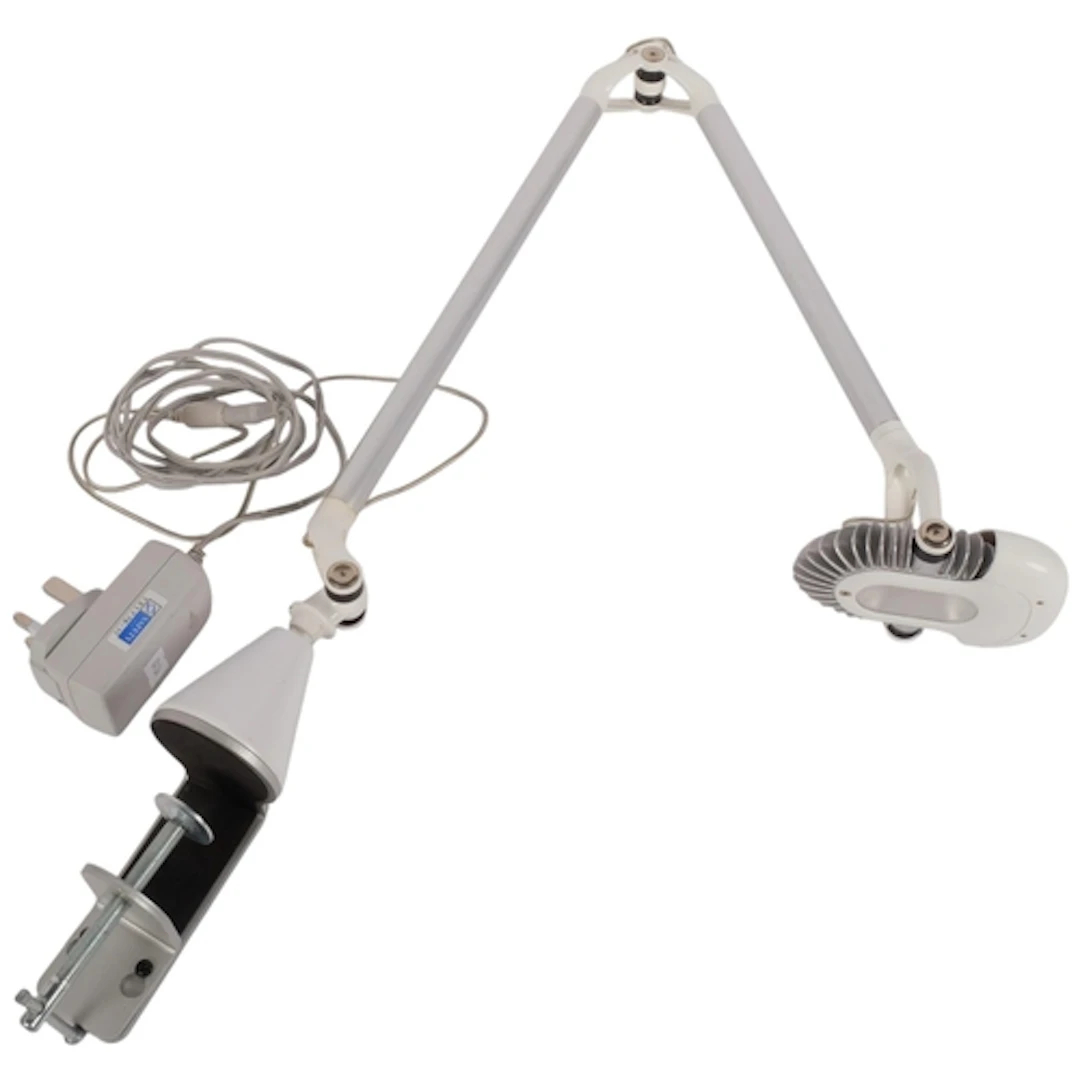 A Humanscale adjustable LED task light, with heavy duty tabl...