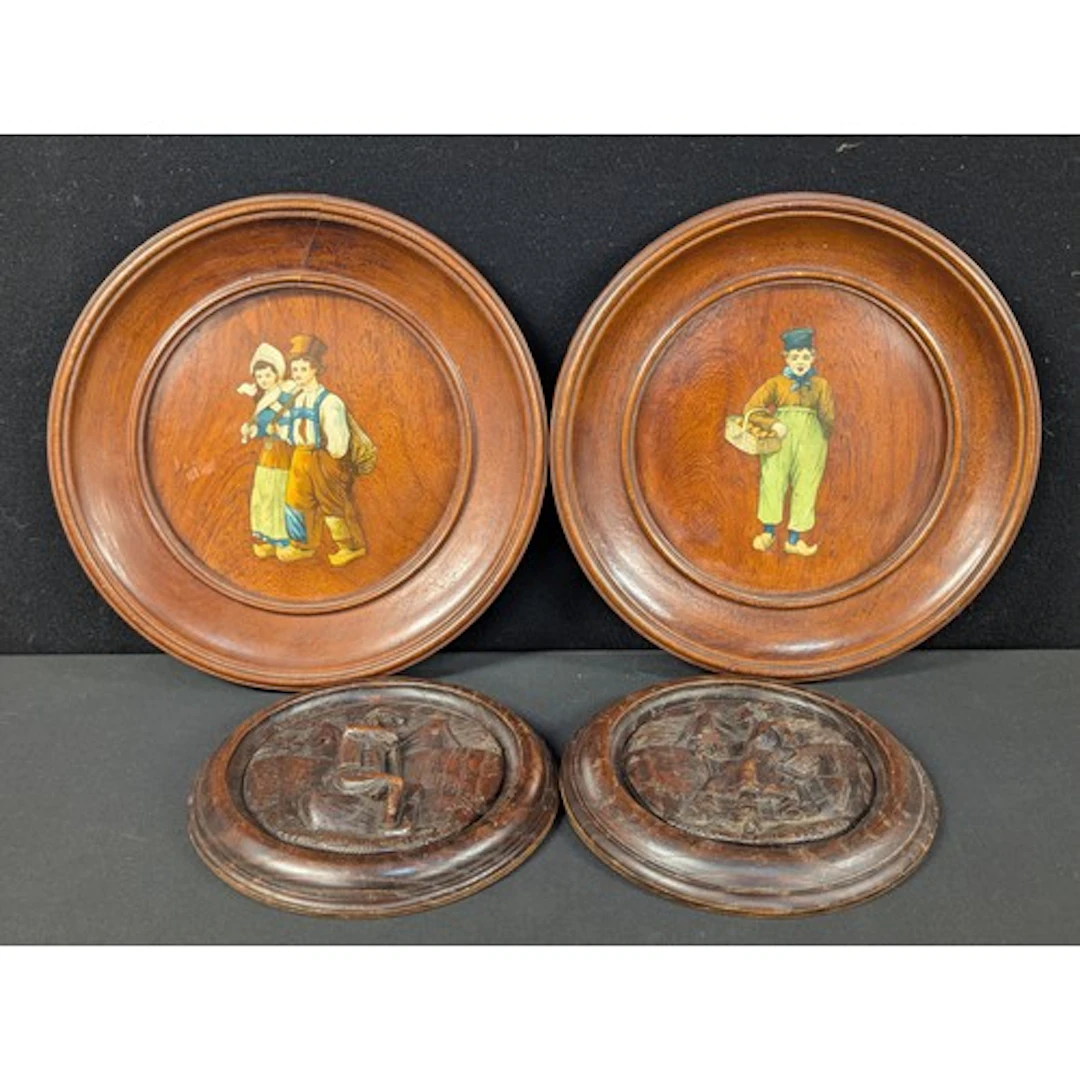 A pair of Black Forest carved plaques, signed; a pair of Ger...