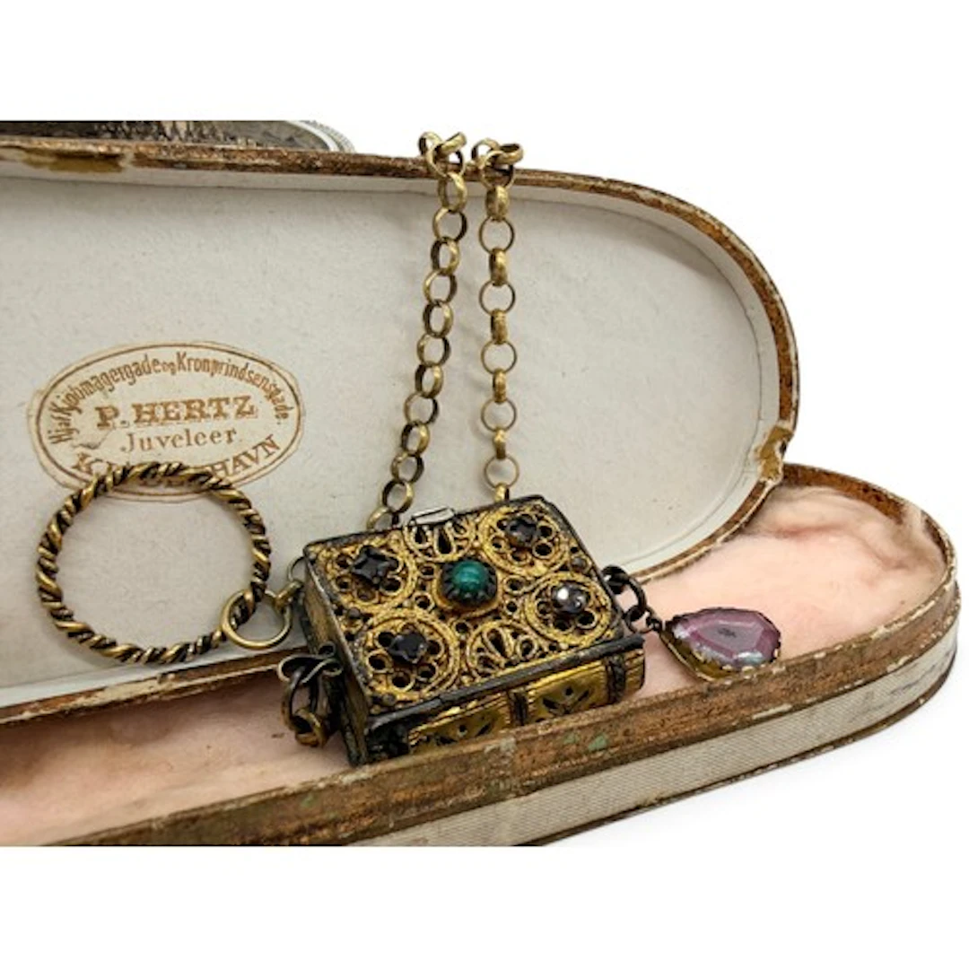 A rare silver-gilt filigree pomander pendant in the form of ...